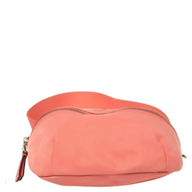 Every bag from Kate Spade is utterly gorgeous and functional! This orange beauty no wonder brings with it the magic of the brand's charm. On the nylon construction, the front is decorated with the logo & a zipper while the adjustable belt allows you