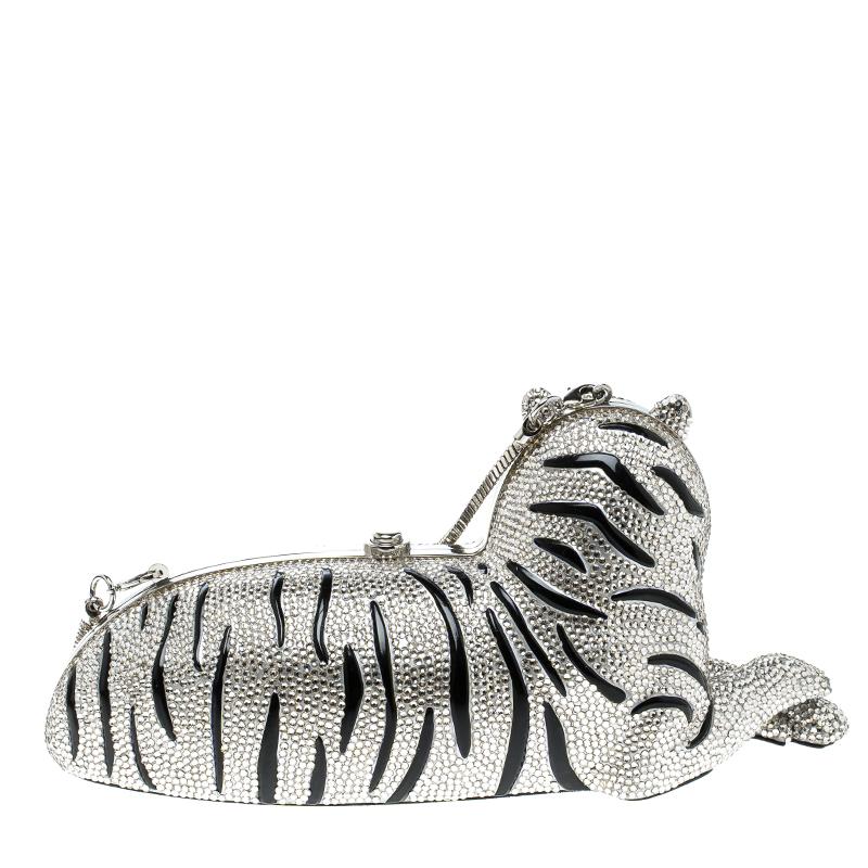 Encrusted with rhinestone and crystals, this charming Place Your Bets Tiger clutch is a unique and innovative design from Kate Spade. It sculpted in the shape of a sitting tiger which is sure to grab attention whenever flaunted. The push-lock