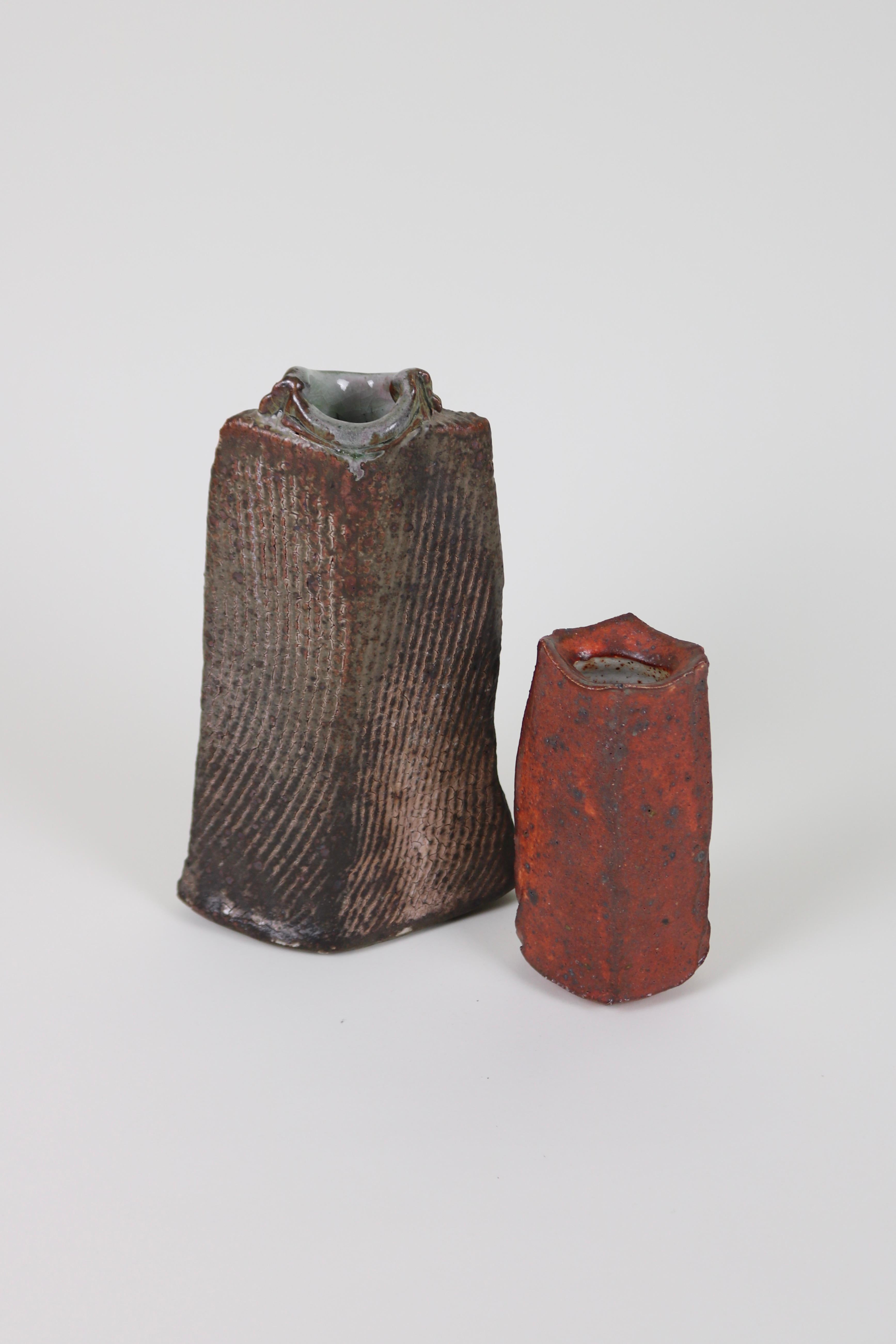 A vase from Greek-born artist Katerina Evangelidou. A wood-fired stoneware bottle form with a textured surface covered in ash glaze.

Evangelidou creates beautifully organic forms. Her process always begins on the wheel, with flattening and