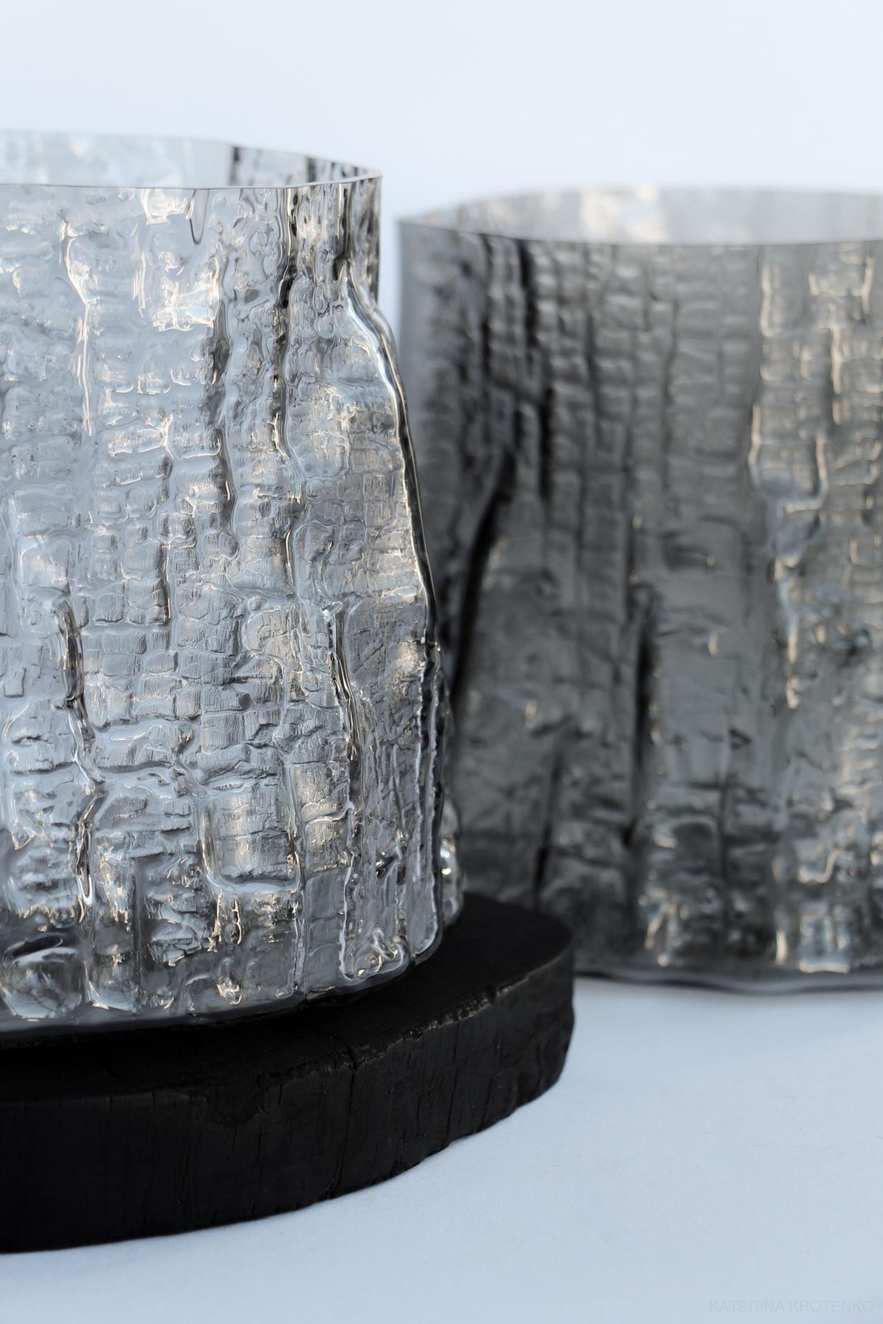 sculptural glass vase, volume IV, smoky light gray
approximate dimensions: 15–18 cm

Shaped by fire collection of glass vessels represents movement in time, the simultaneity of the past and the future. The making process is a captivating synergy of