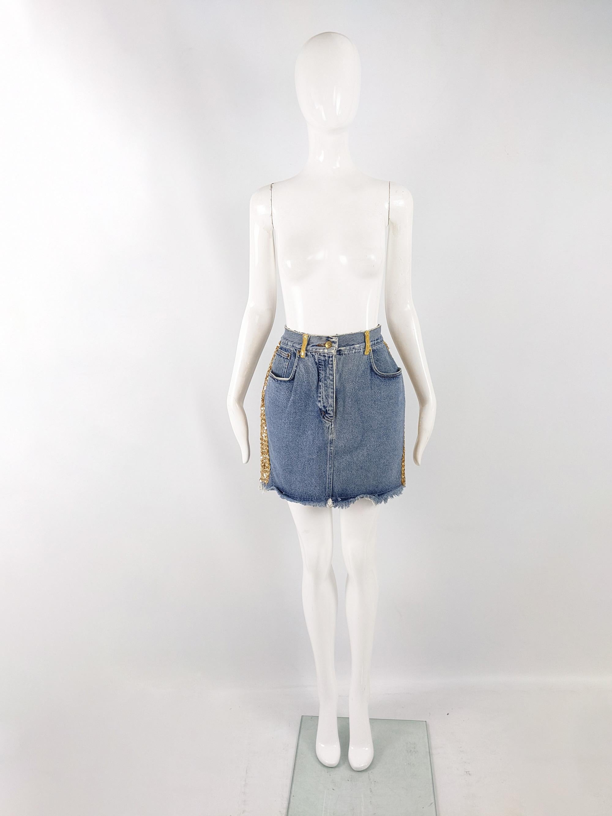 An incredible and rare vintage mini skirt from the late 80s/ early 90s by iconic British fashion designer, Katharine Hamnett. In a blue denim with a frayed hem and gold sequin trim to the side and belt loops, giving a glam rock look.

Size: Marked