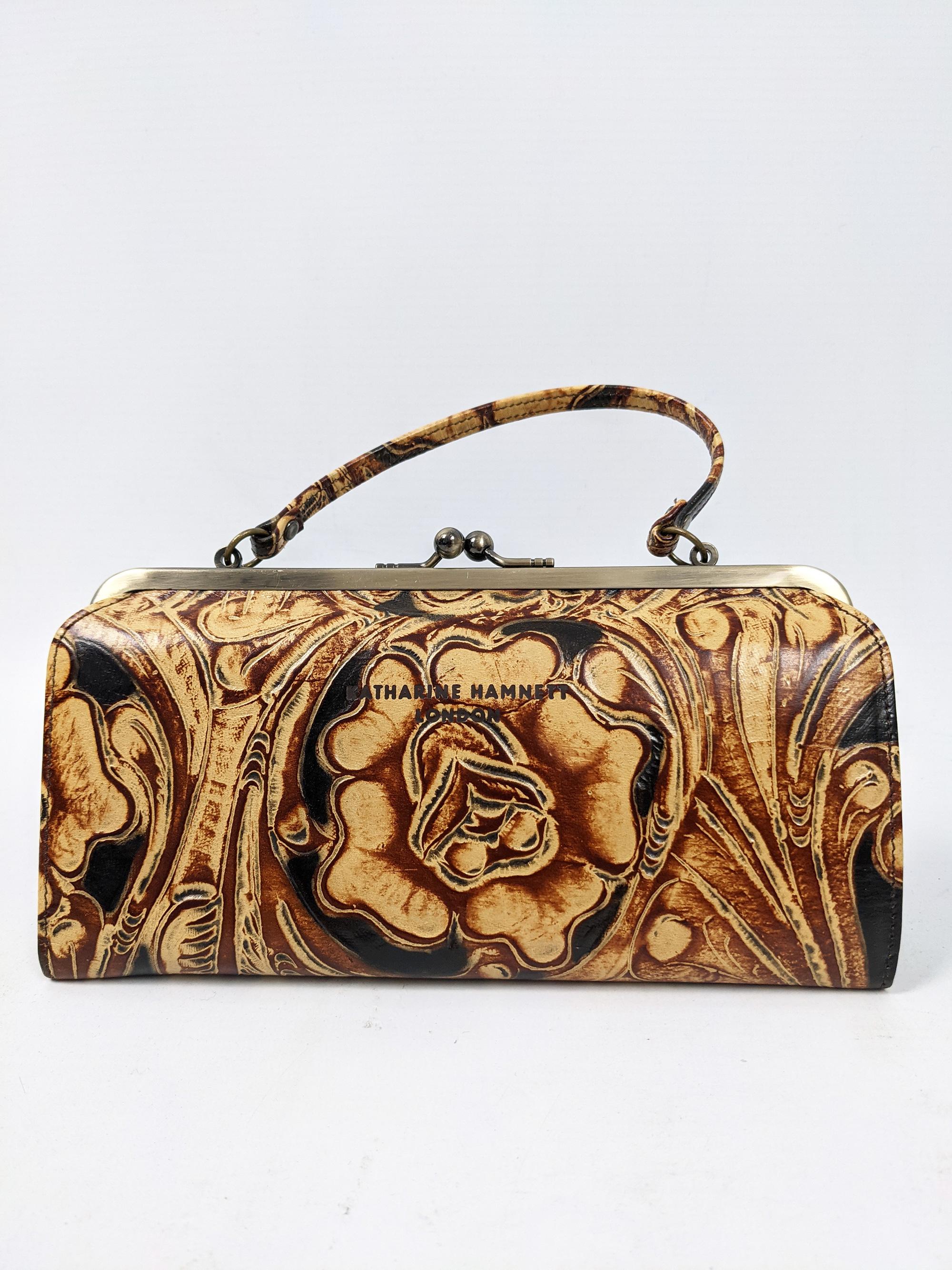 A super cute and tiny vintage Katharine Hamnett mini frame handbag / purse in a brown floral embossed leather with  clasp fastening and short handle. 

Size: 
Length - 20cm / 7.5