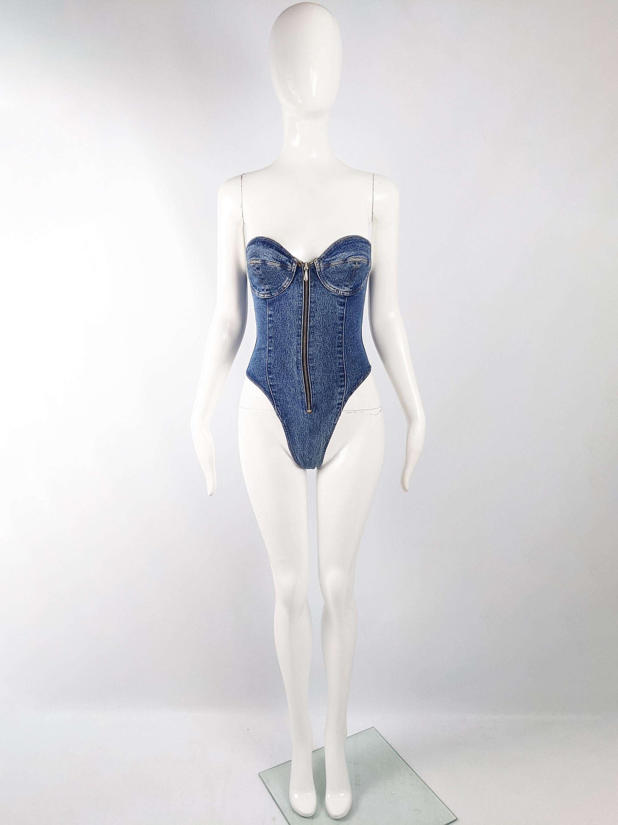 An incredible and rare vintage womens Katharine Hamnett denim leotard / bodysuit from the late 80s / early 90s. In a blue denim with amazing construction, it has a panelled back that gives a flattering silhouette and a zip front with a sweetheart