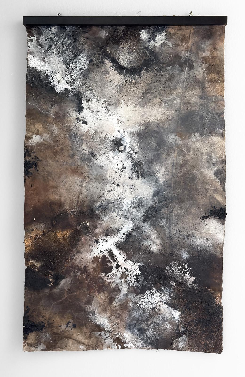 "We Become the Breath, Silence and Light Between the Leaves" is a 39.5 x 23-inch painting on buried canvas and the newest work by Katherine Filice, composed of ink, charcoal, embers, found objects, and chalk. Immersive and meditative, this work