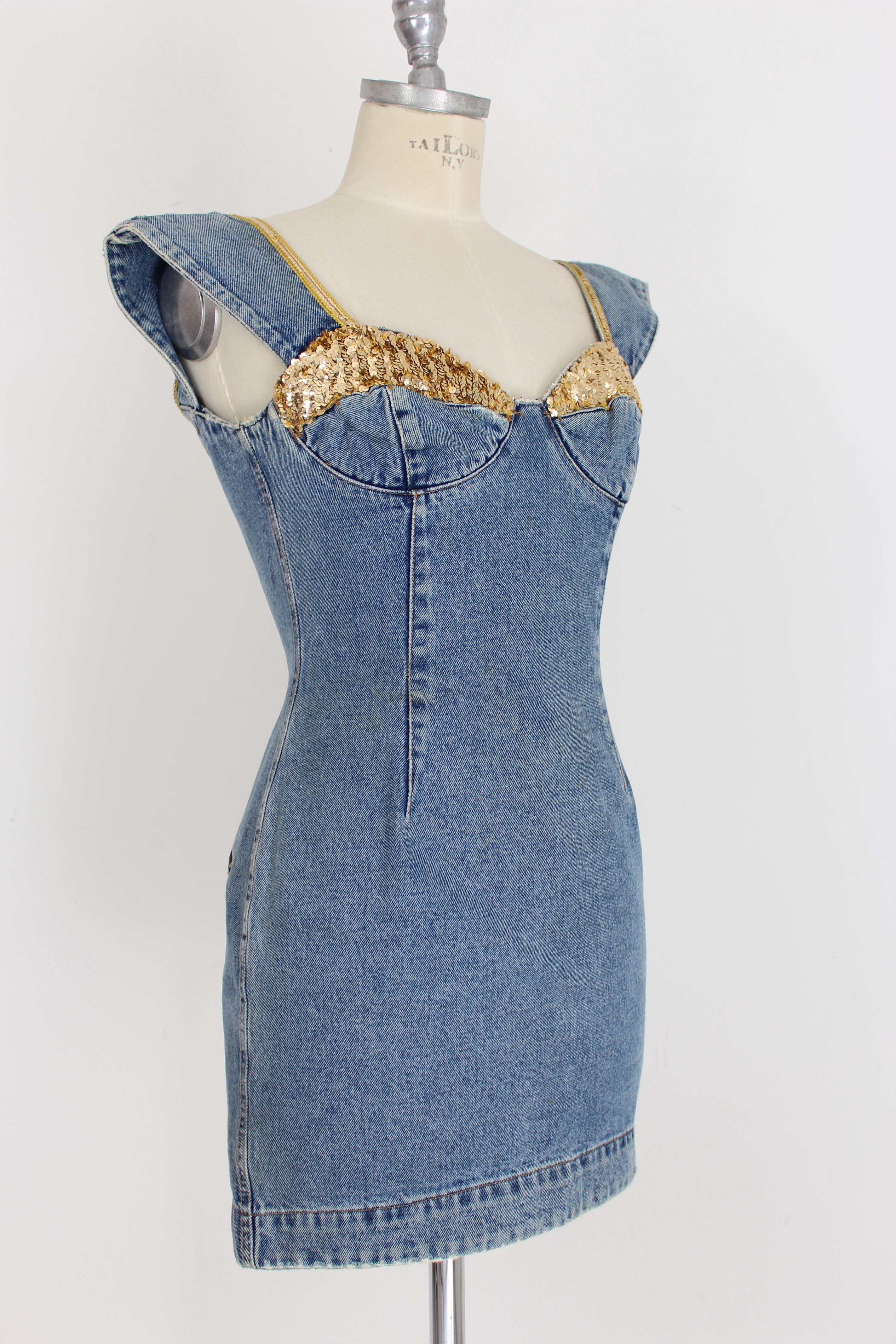 Katherine Hamnett vintage 90s woman dress. Short blue denim dress, sweetheart neckline. Golden sequin applications on the breast and straps. Zipper closure on the back, two pockets on the bottom of the back. 100% cotton fabric. Made in Italy. Very
