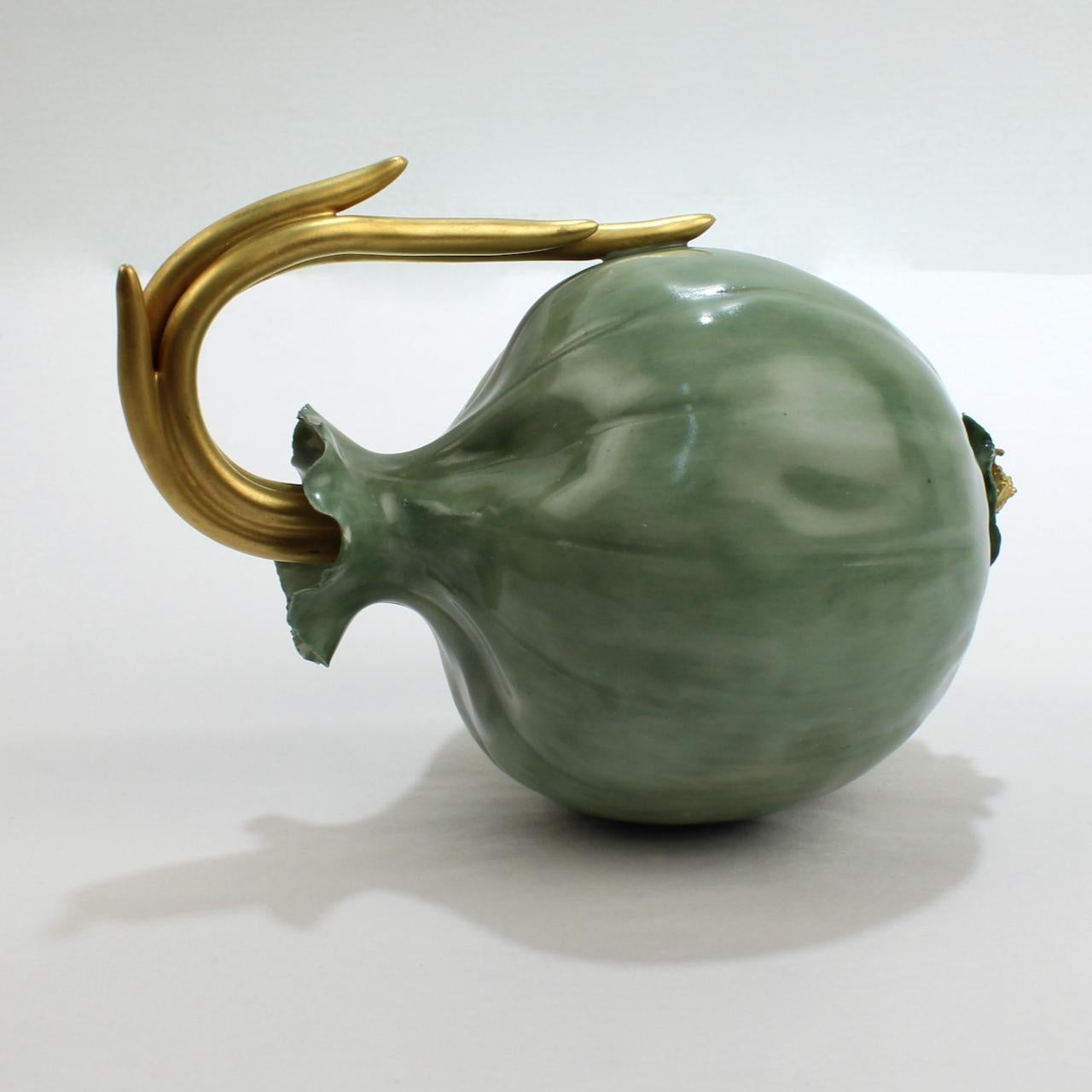 A fine Katherine Houston green onion.

Delicately modeled with a green glazed body and gilt shoots and roots.

From the estate of Susan & John Gutfreund (The 'King of Wall Street').

Date:
2000

Maker:
Katherine Houston

Marks: 
KHO '00