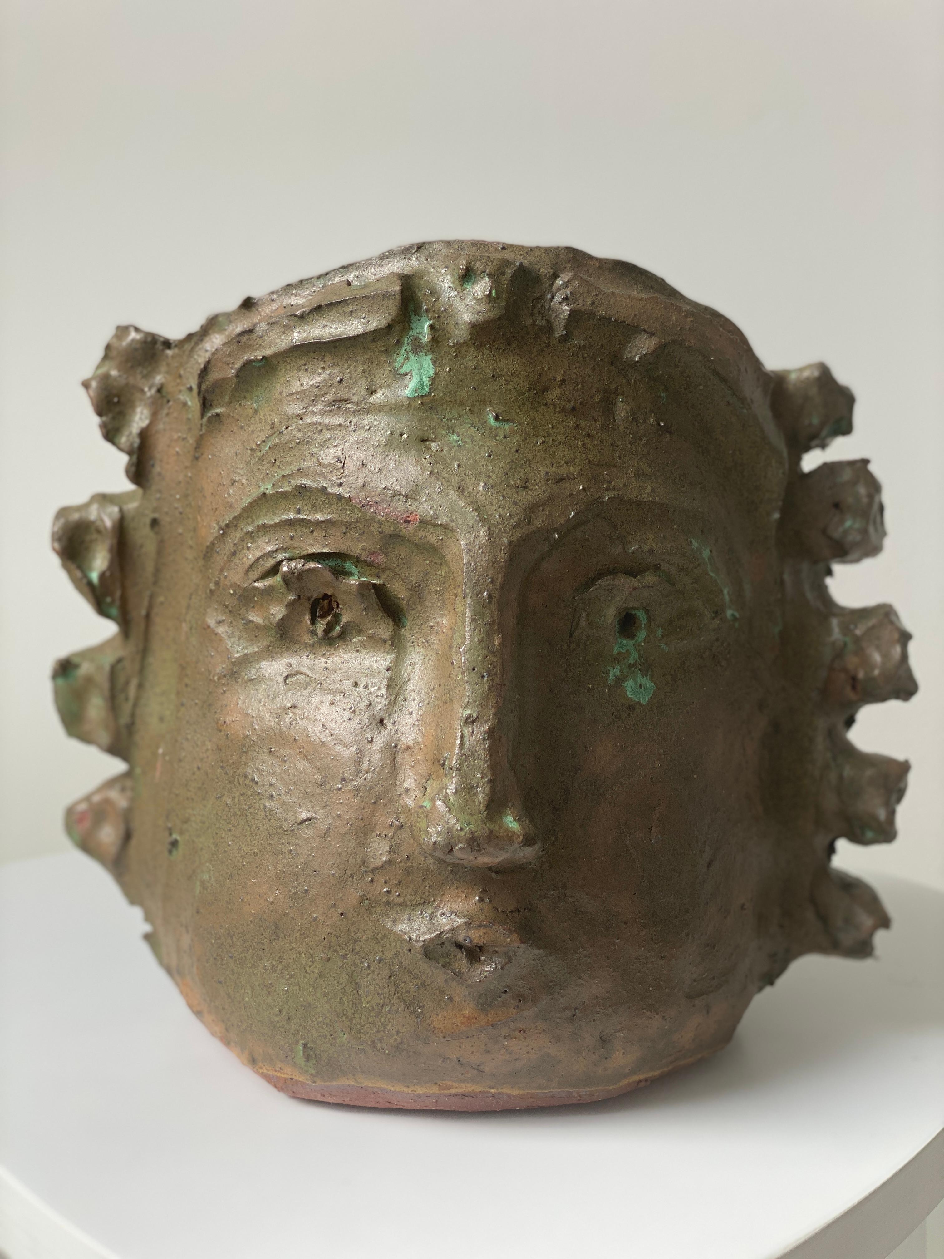 Introducing this extraordinary, handcrafted clay face and head vase, radiating deep green hues and earthy tones. 

Experience the essence of true craftsmanship with our captivating deep dark olive green and tan rustic clay head vase. Hand-built and