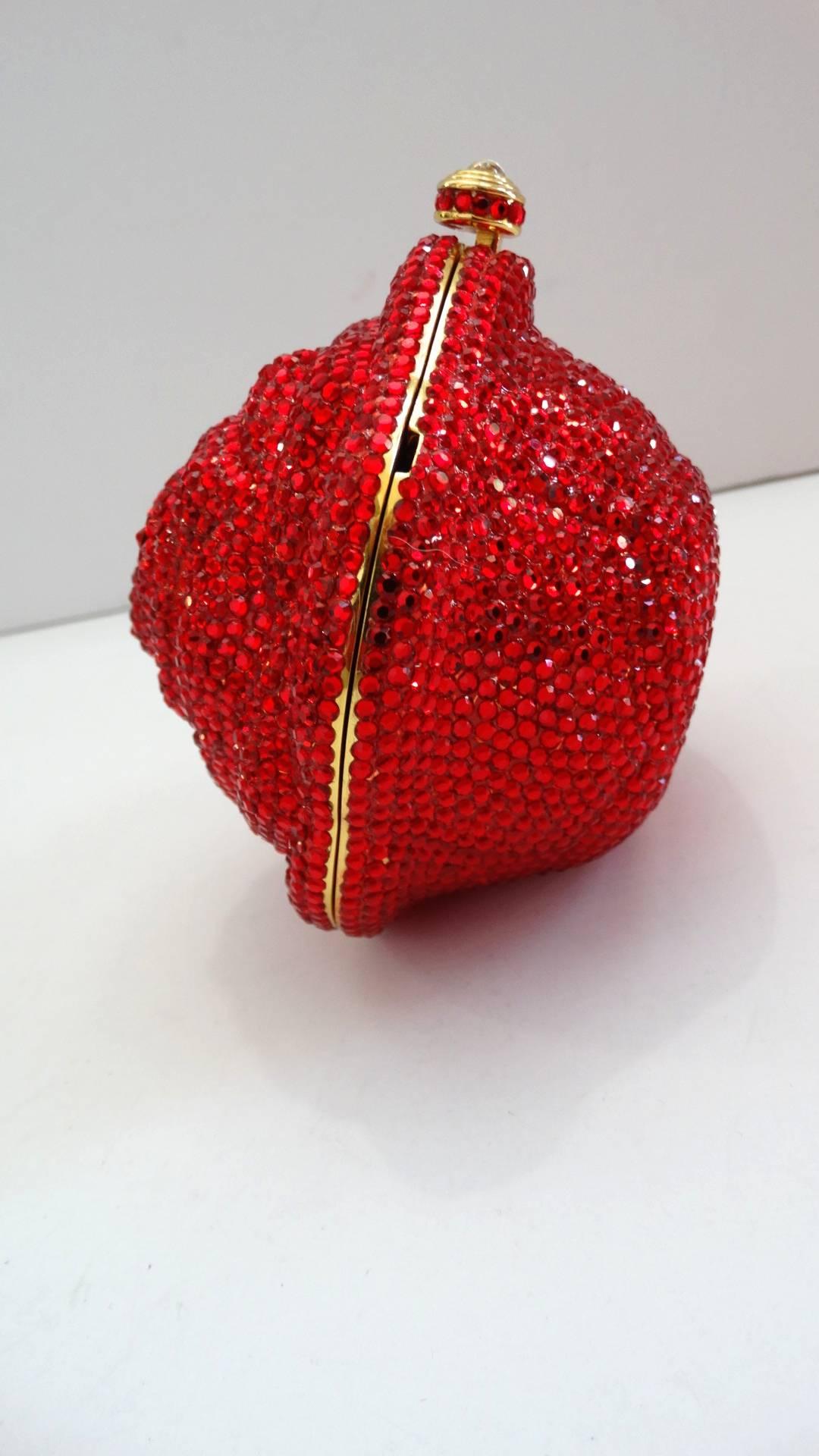 Add some dazzle to your evening wear with this incredible Kathrine Baumann Beverly Hills minaudière! Red rose shaped construction with carved out petals, all covered in brilliant red Swarovski crystals! Push lock closure accented with crystal