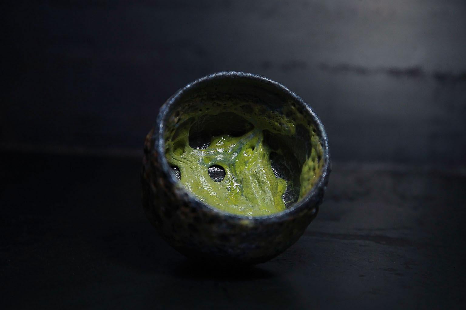 wheelthrown ceramic bowl made of black clay with slime in the inner
