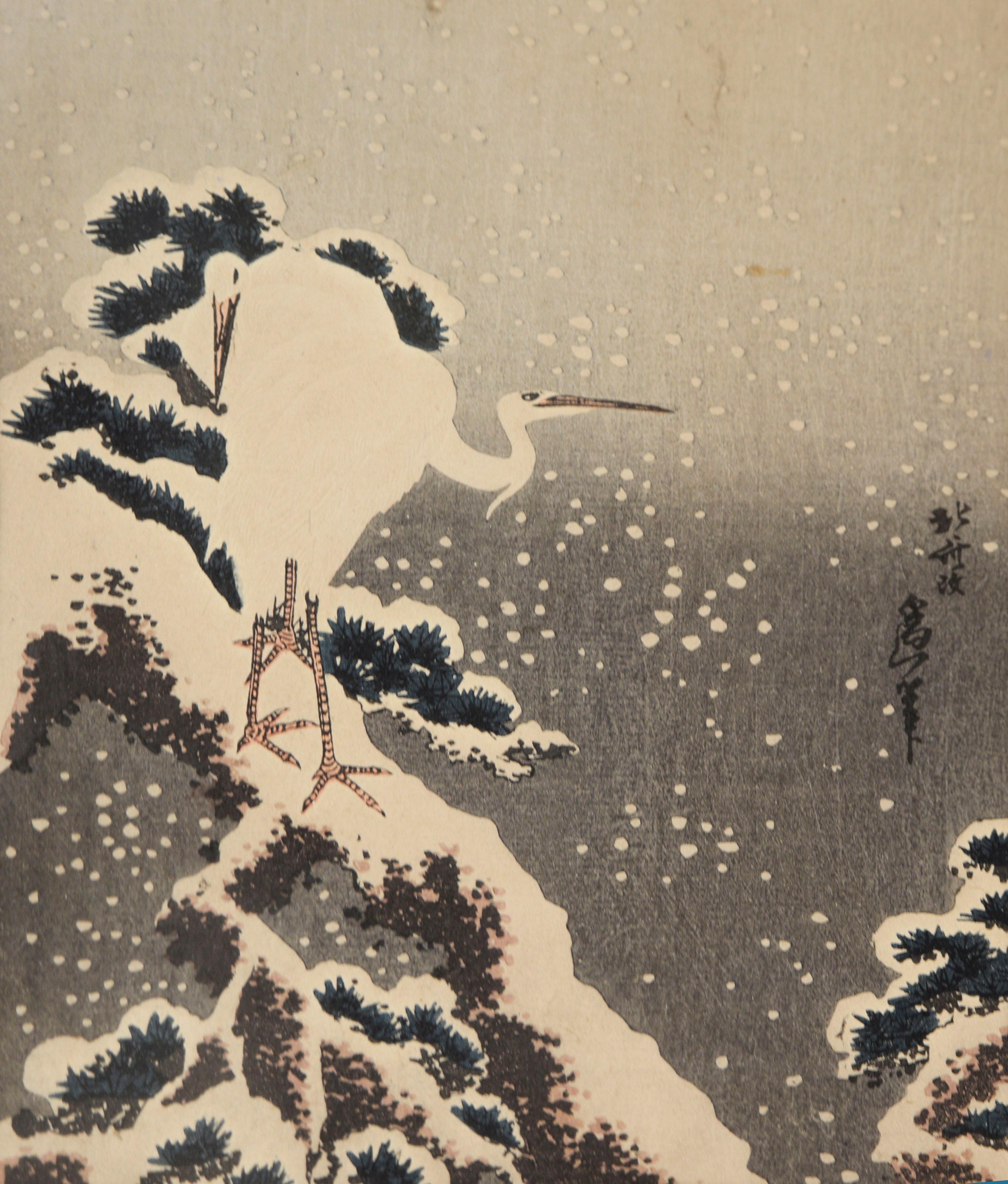 Egret and Mt. Fuji - Woodblock Print

Two white egrets stand on the side of a mountain with a snow covered Mt. Fuji in the background by Katsushika Hokusai (Japanese, 1760–1849). Snowflakes fall over a deep blue and grey background, with snow