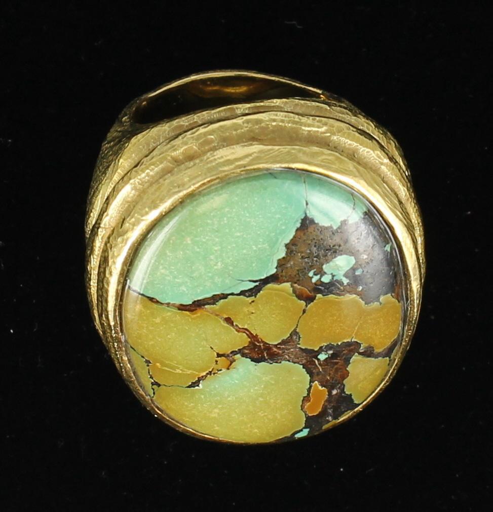 This highly unusual and beautiful piece of Chinese Turquoise is enhanced by its one of a kind hand made 18 karat yellow gold mounting.The ring weighs 46.8 grams and is currently a size 8.5 and is sizable. The styling of this ring is the product of 