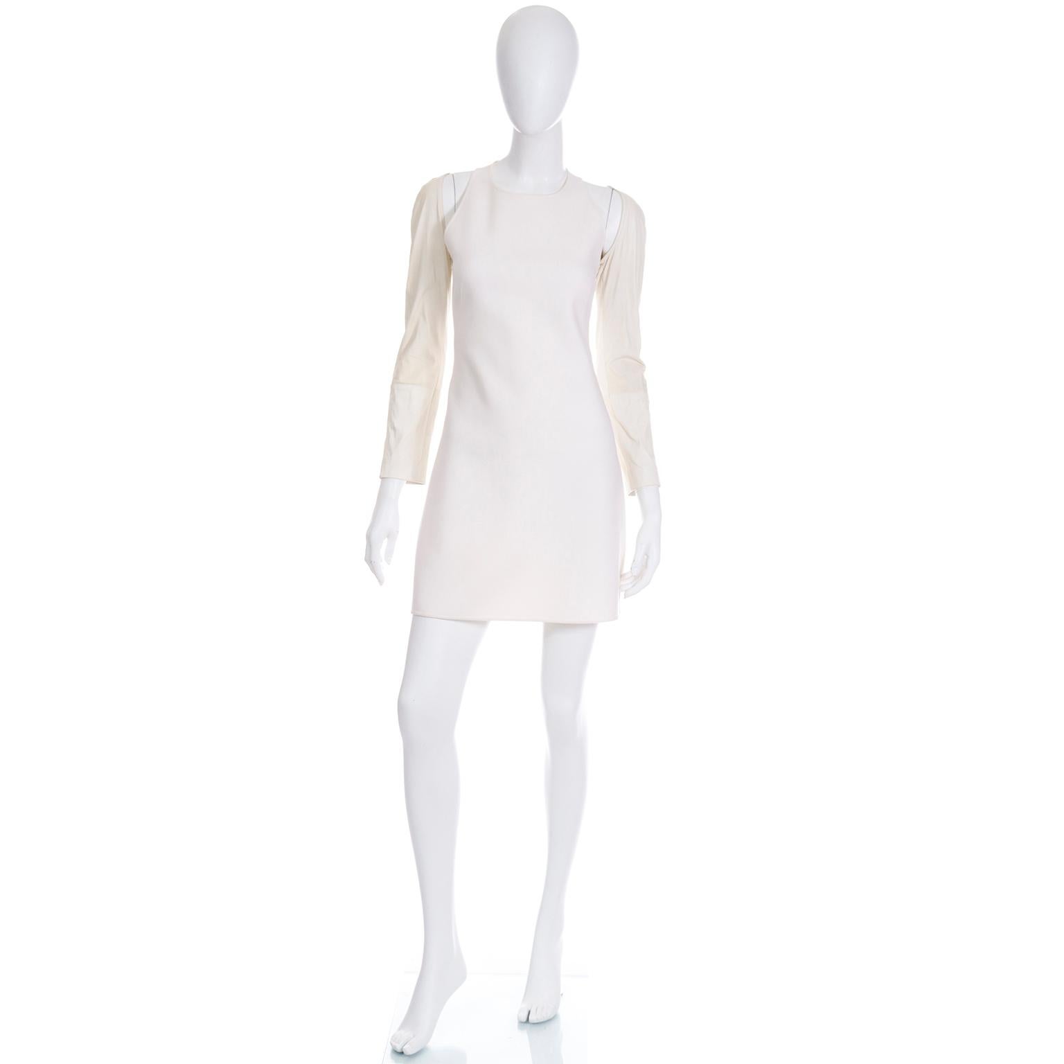 This Kaufmanfranco ivory stretch crepe dress has fun cutouts in the bodice and fabulous cream leather sleeves. We love the interesting seam details that define the silhouette. Closes with a hidden back center zipper. 
The dress body is made of a