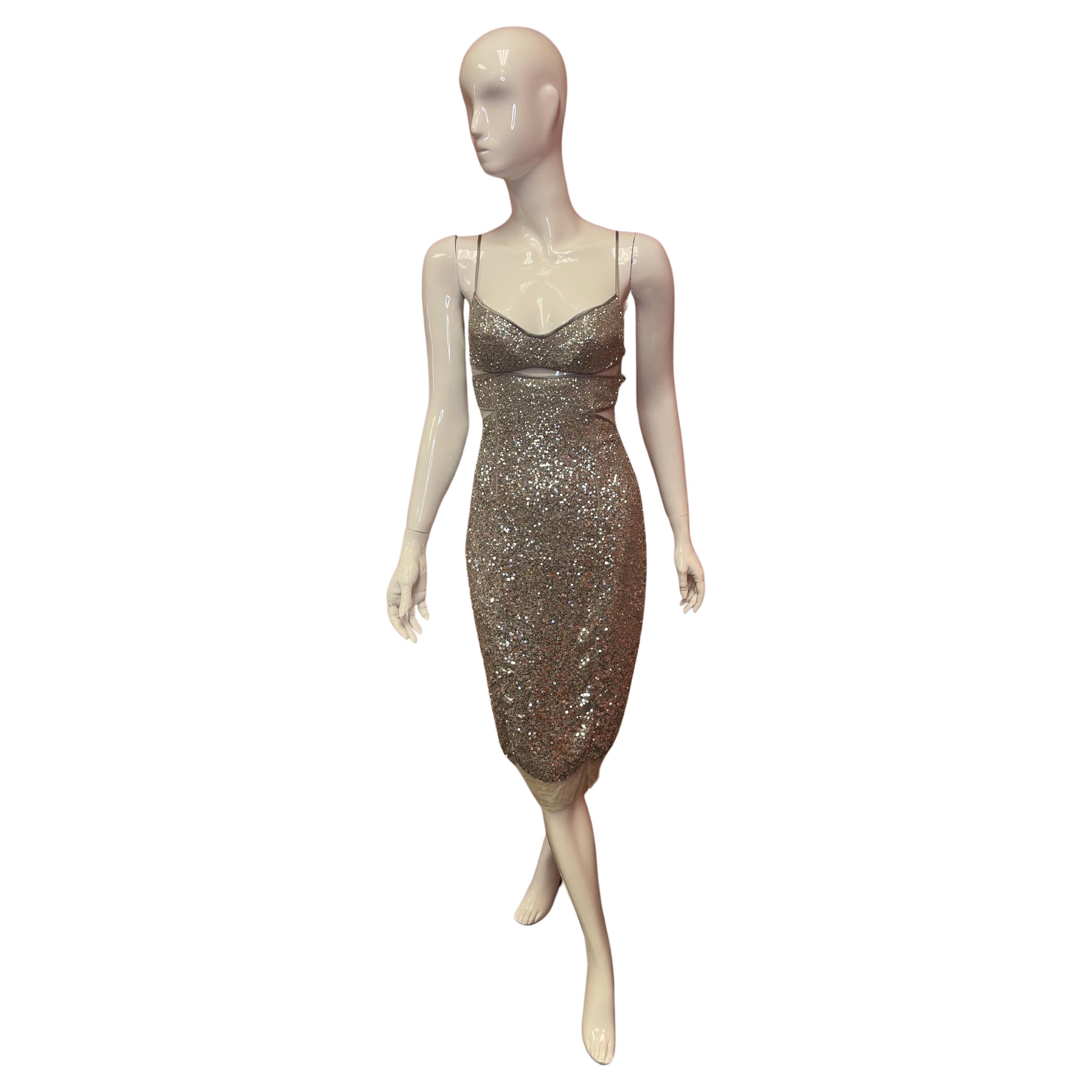 This amazing Kaufmanfranco cocktail dress is sure to dazzle. Sexy cutouts on the side body, with spaghetti straps are balanced with a below knee hem. Silk lined with silver sequins. Zip and hook and eye closure. 
Sized US 6 / EU 42 
Priced at