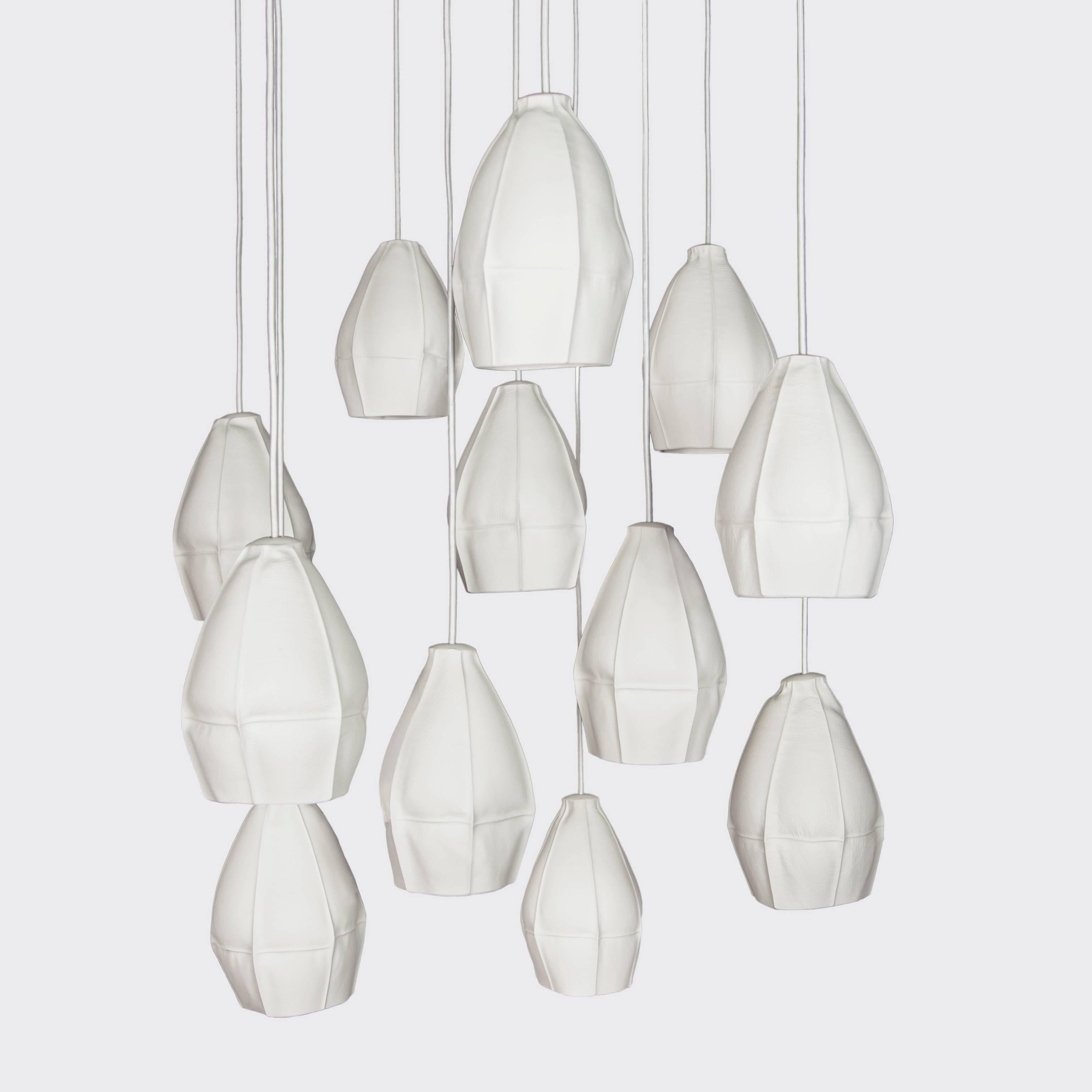 Souda's Kawa pendant lights are slip cast porcelain directly into dozens of leather molds resulting in highly-unique ceramic shades. The finalized pendant lights are dynamic and highly-unusual, emitting a soft glow that works well individually or in