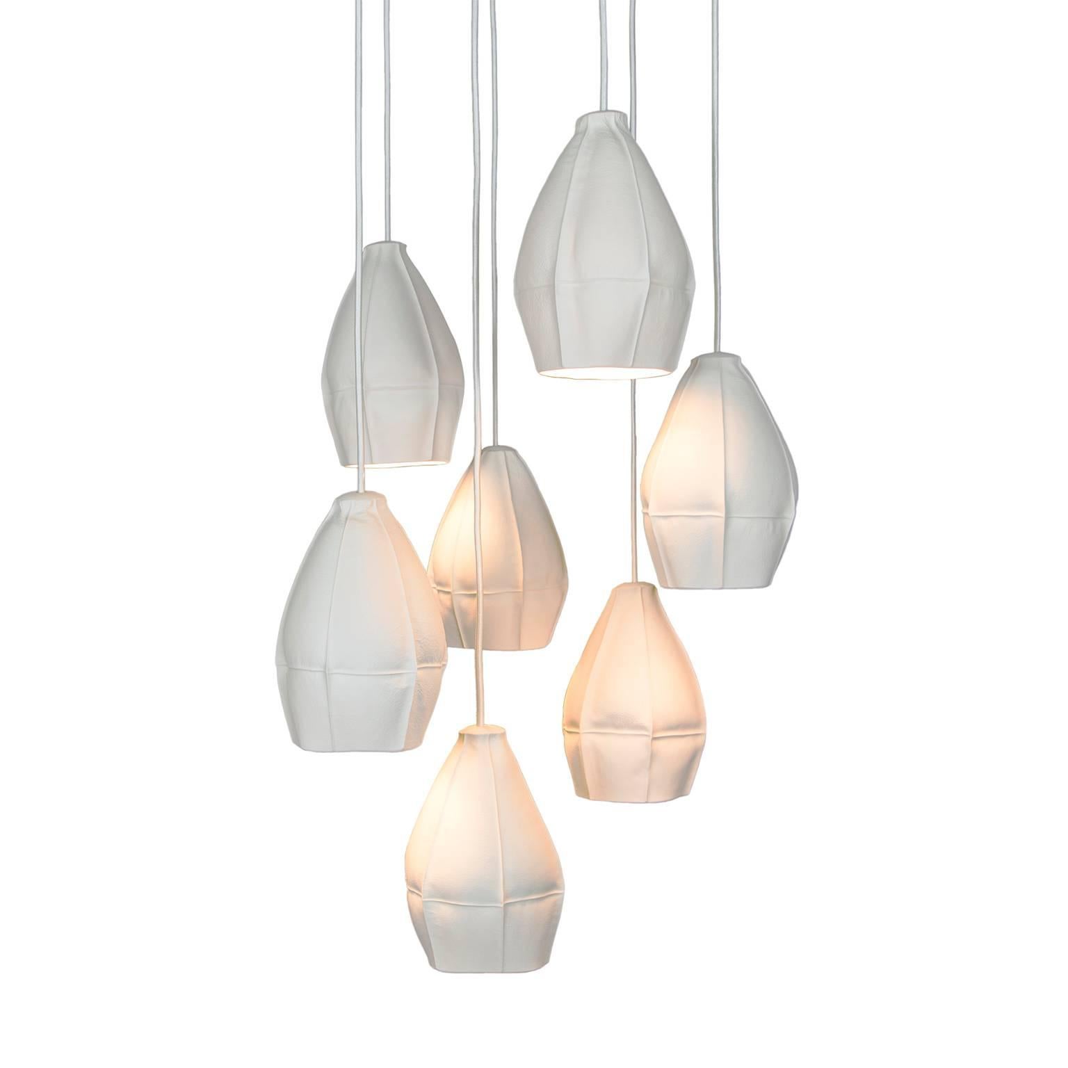 Souda's Kawa Pendant Lights are slip cast porcelain directly into dozens of leather molds resulting in highly-unique ceramic shades. The finalized pendant lights are dynamic and highly-unusual, emitting a soft glow that works well individually or in