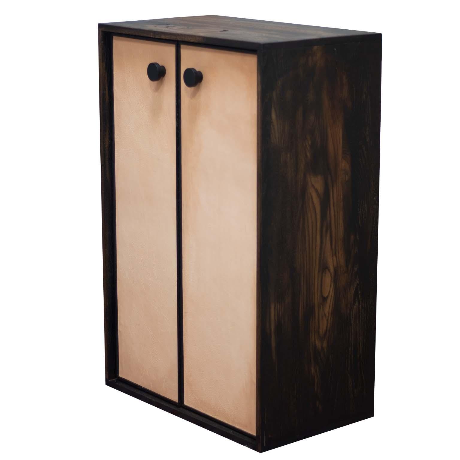 This Kawakami cabinet features a faux antique finish on distressed solid oak with beautiful natural leather doors and cabinet handles from Bacman and Berglund.

This cabinet is not short on fine details, such as an inner solid walnut frame