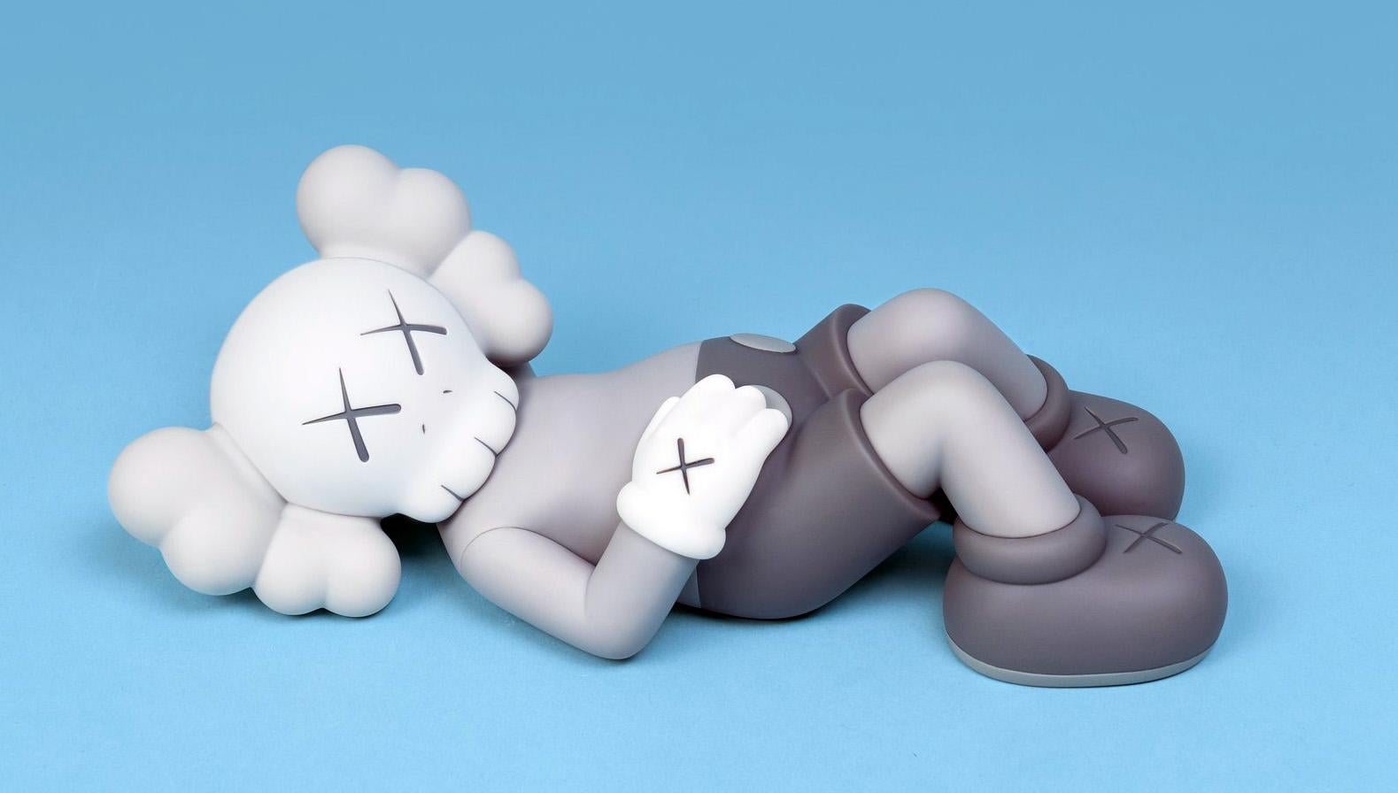 KAWS Grey Holiday Companion Japan (KAWS Mount Fuji Japan):
This sold out KAWS figurative piece features KAWS' signature character COMPANION in a resting position. Published by All Rights Reserved to commemorate the debut of KAWS’ 40-meters-long