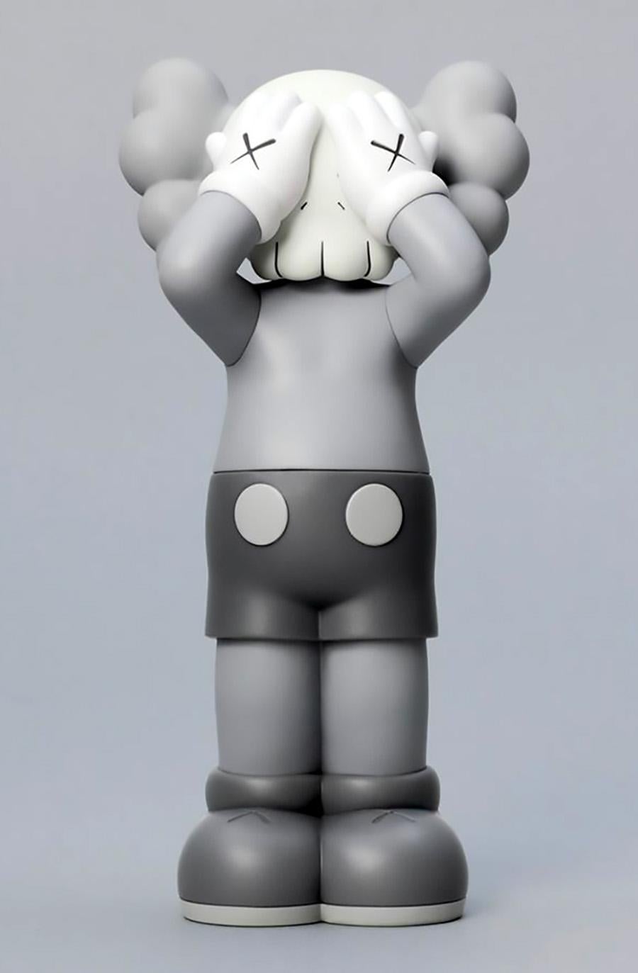KAWS: HOLIDAY United Kingdom Grey (KAWS UK): 
KAWS' signature character COMPANION presented in an upright standing position with its eyes covered. New in their original packaging - published by All Rights Reserved to commemorate the debut of KAWS’