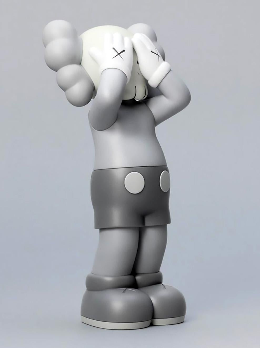 KAWS: HOLIDAY United Kingdom Grey (KAWS UK): 
KAWS' signature character COMPANION presented in an upright standing position with its eyes covered. New in their original packaging - published by All Rights Reserved to commemorate the debut of KAWS’