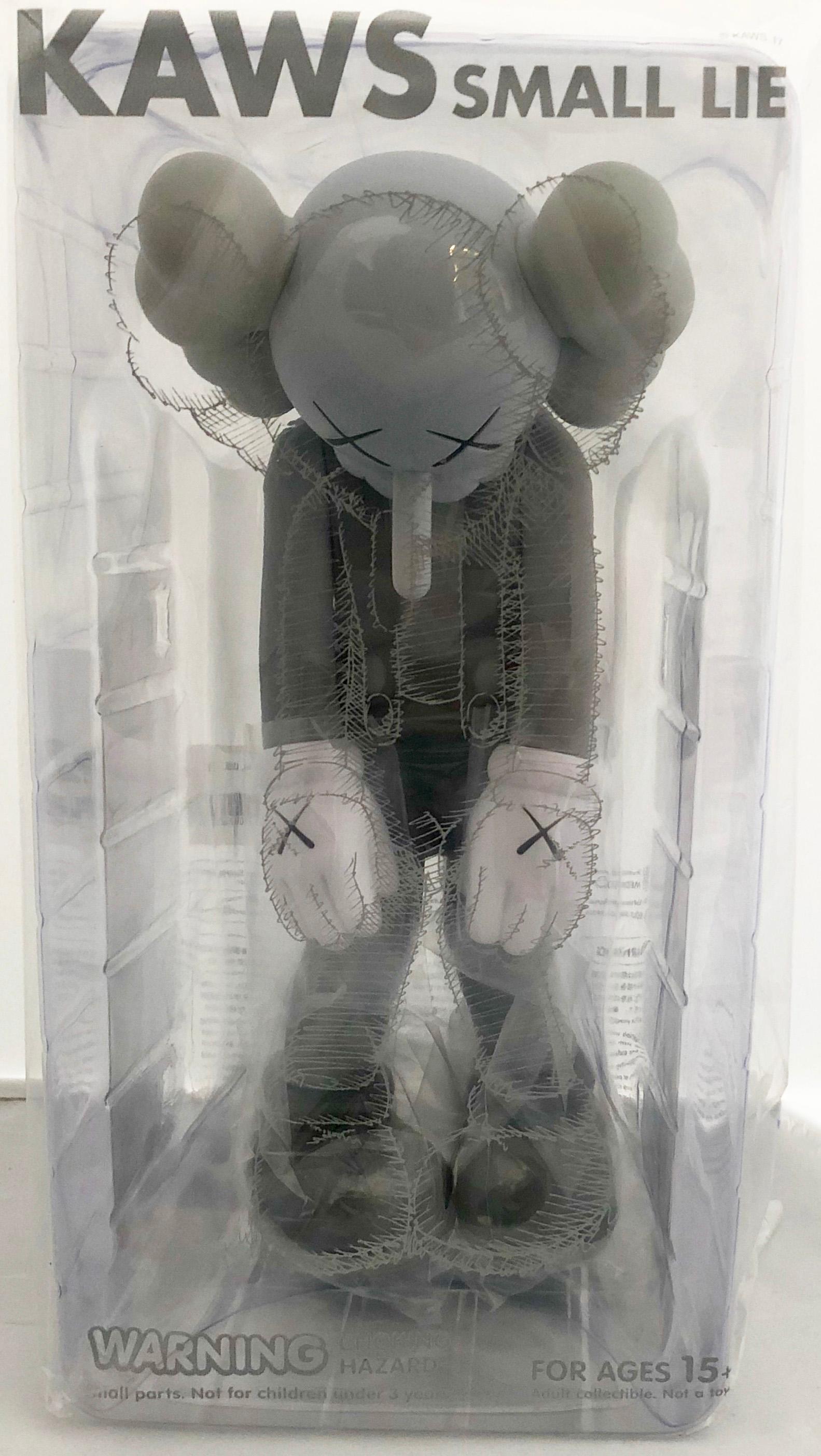 KAWS Small Lie: Set of 2 (black and grey). Each new and sealed in their original packaging. 

Medium: Painted vinyl cast resin. 
Year: 2017. 
Dimensions: 11 × 4.5 inches (applies to each individual) 
New/unopened; excellent condition (applies to