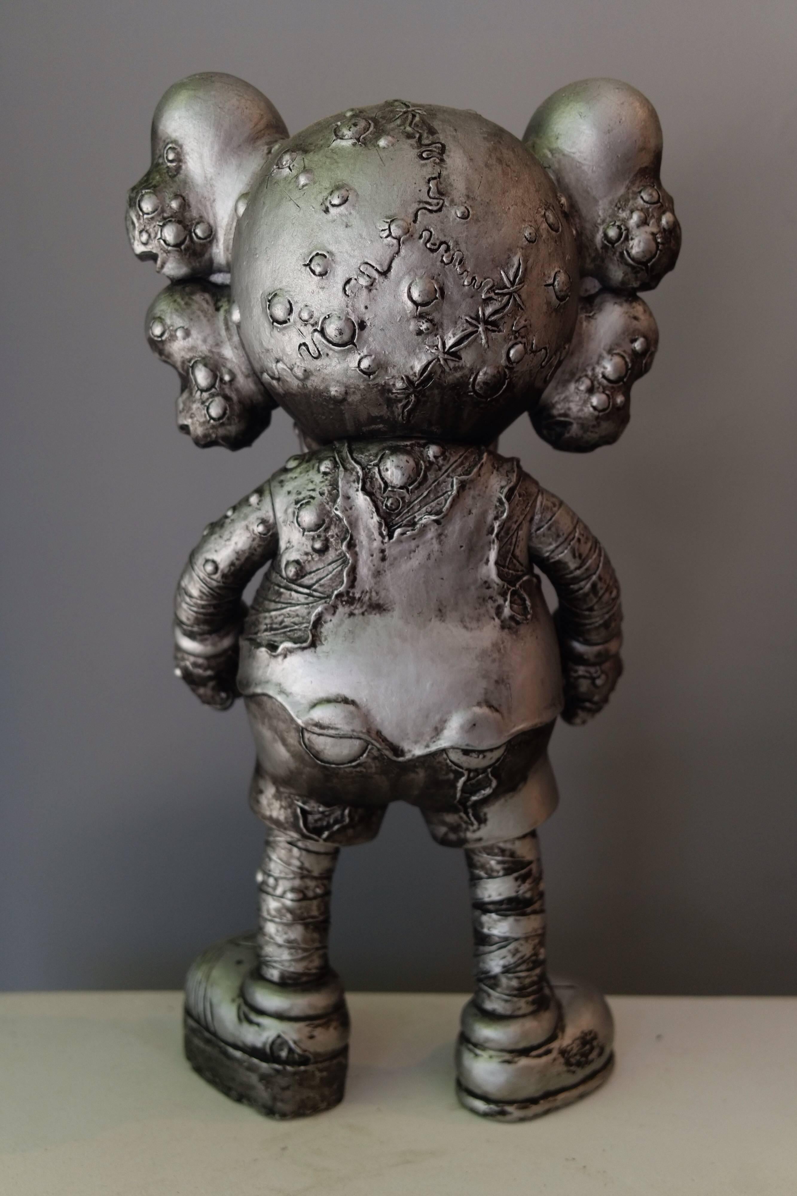 Kaws, Pushhead Version Companion, 2005. 
Kawsone(dot)com. 

Silver. Sculpted by Cosmo Liquid.
Painted cast vinyl. 
From an edition of 500. 
In its original packaging / box. 
Produced and manufactured Medicom Toy Corporation, China. 

About