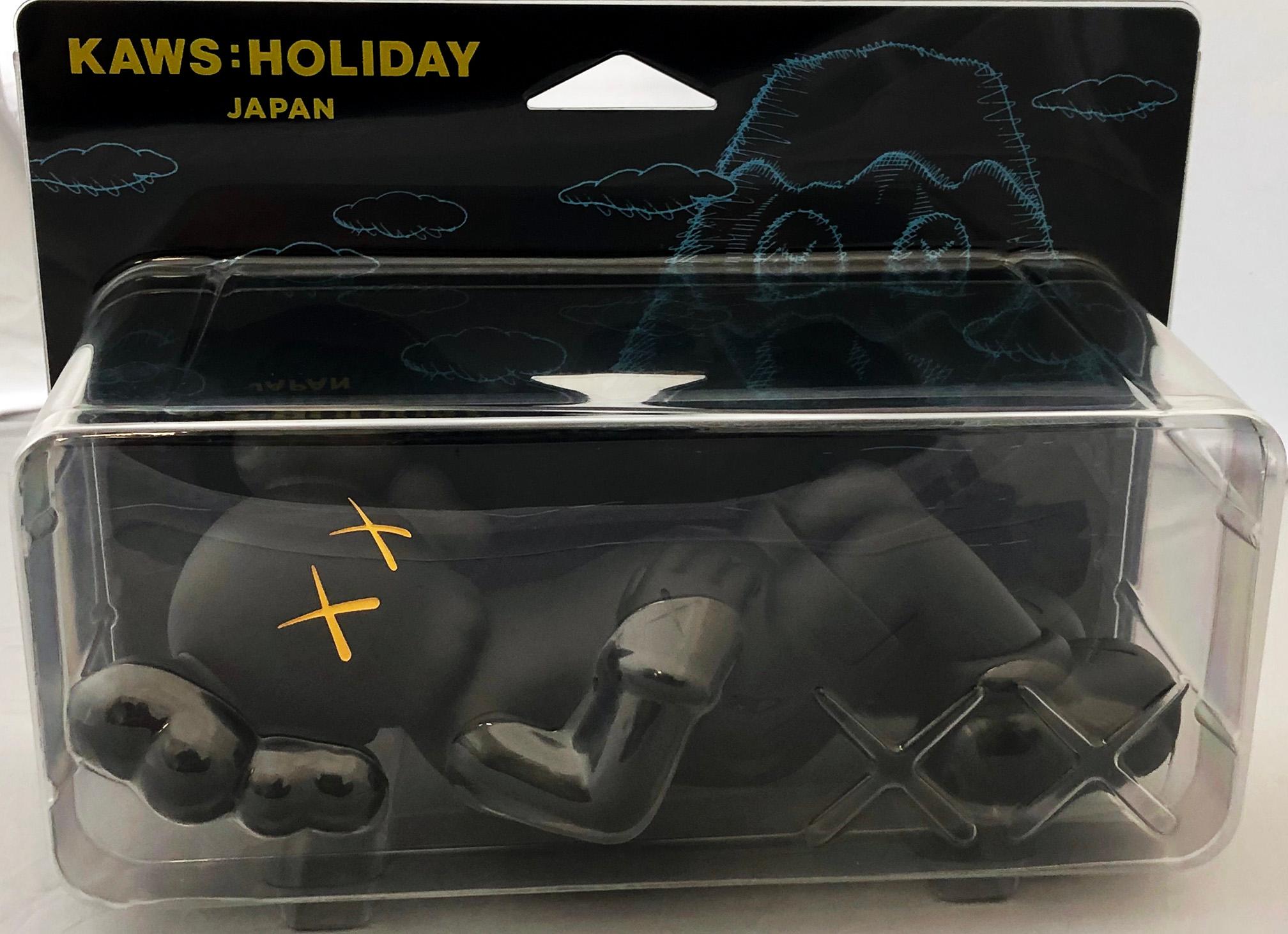 KAWS Black Holiday Companion (KAWS Mount Fuji Japan): 
This sold out figurine features KAWS' signature character COMPANION in a resting position. This figurine was published by All Rights Reserved to commemorate the debut of KAWS’ 40-meters-long