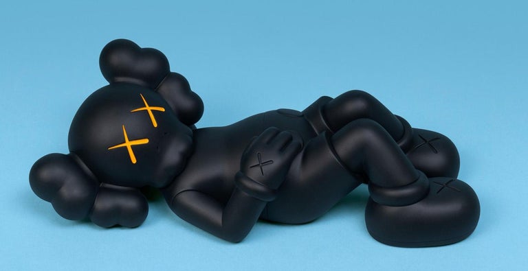KAWS Black Holiday Companion (KAWS Mount Fuji Japan): 
This figurative vinyl sculpture features KAWS' signature character COMPANION in a resting position. Published by All Rights Reserved to commemorate the debut of KAWS’ 40-meters-long figure