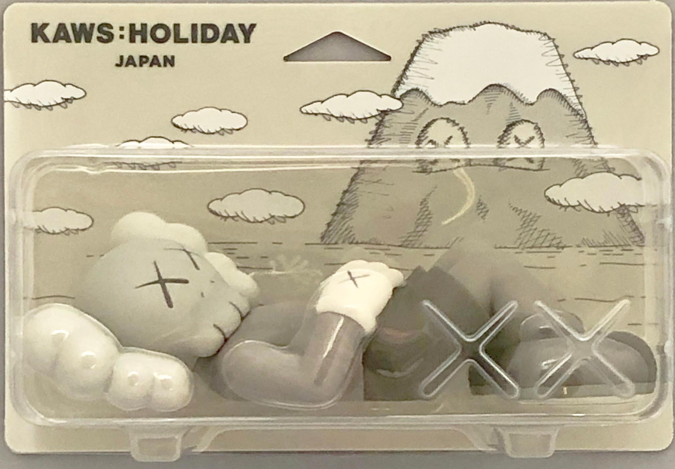 KAWS Grey Holiday Companion (KAWS Mount Fuji Japan):
This sold out figurine features KAWS' signature character COMPANION in a resting position. This figurine was published by All Rights Reserved to commemorate the debut of KAWS’ 40-meters-long