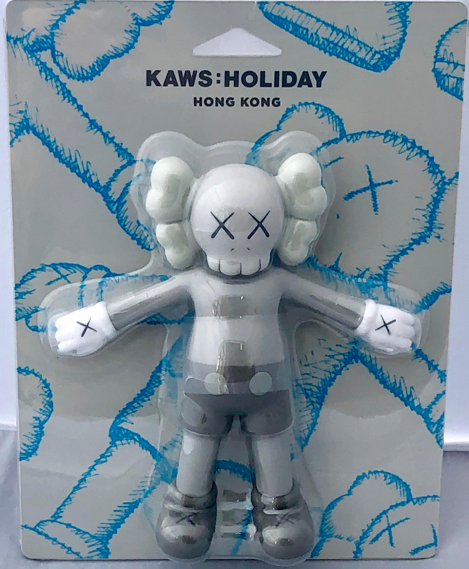 KAWS Hon Kong 'Holiday' Companion 2019:
This figurine was published by All Rights Reserved to commemorate the debut of a large scale KAWS floating figure in Hong Kong's Victoria Harbour in 2019. New in its original packaging. 

Medium: Vinyl art