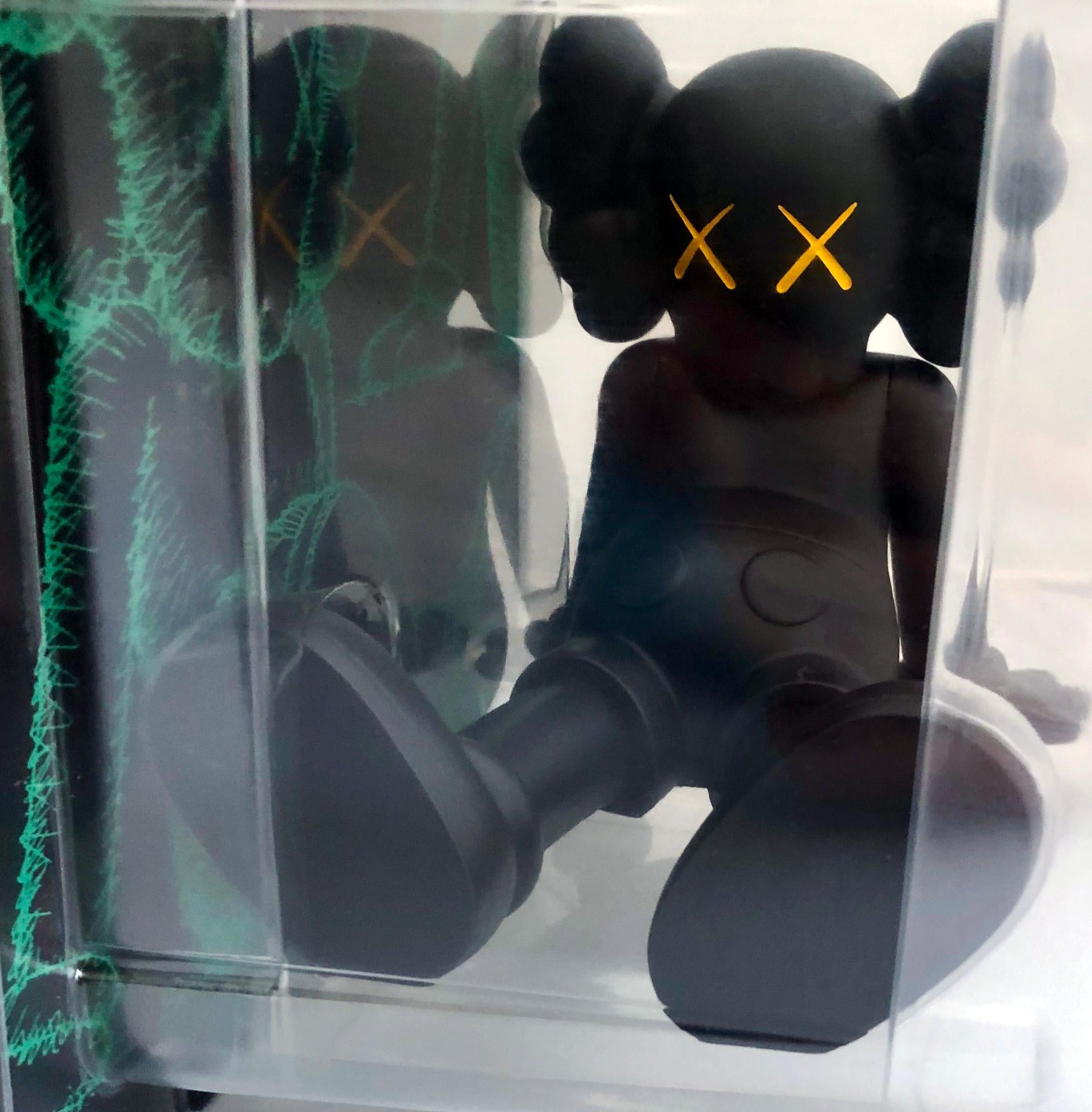 kaws figure laying down