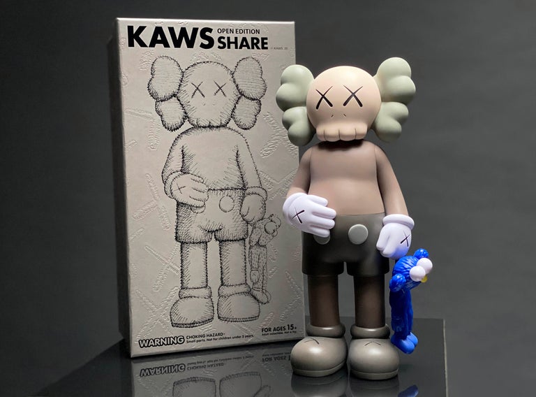 The ‘KAWS SHARE 20’ is a vinyl art toy in a neutral brown and cobalt blue color scheme made in collaboration with Medicom Toy by KAWSONE. The art toy figure is based on the KAWS installation of a 72″ bronze sculpture a part of the ‘KAWS: Blackout’