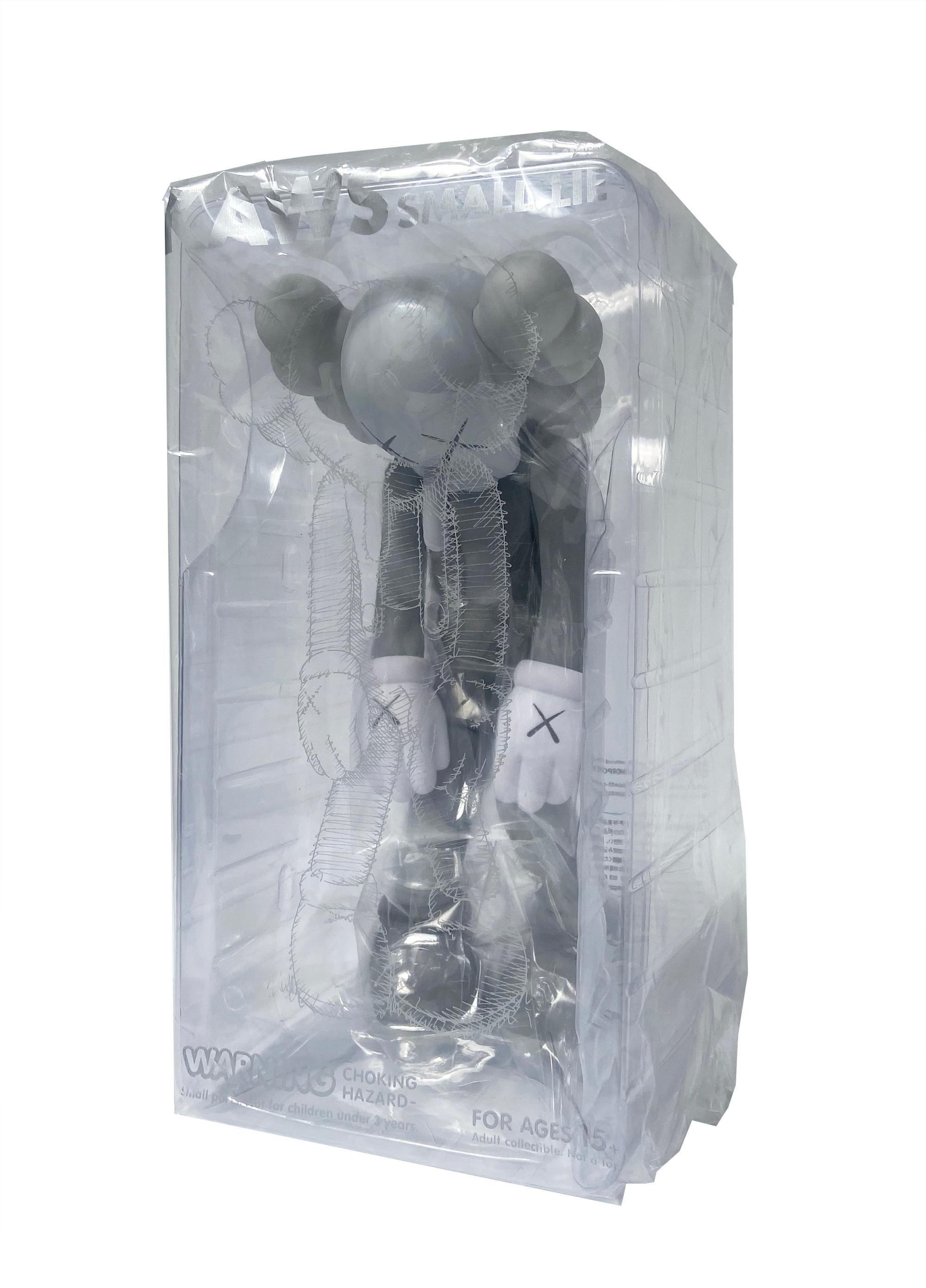 KAWS Small Lie Companion: Set of 2 works (brown and grey). Each new and sealed in their original packaging. 

Among KAWS’s signature “Companions,” Small Lie has the most childlike resonance. Clothed in overall shorts, the Pinocchio-inspired figure