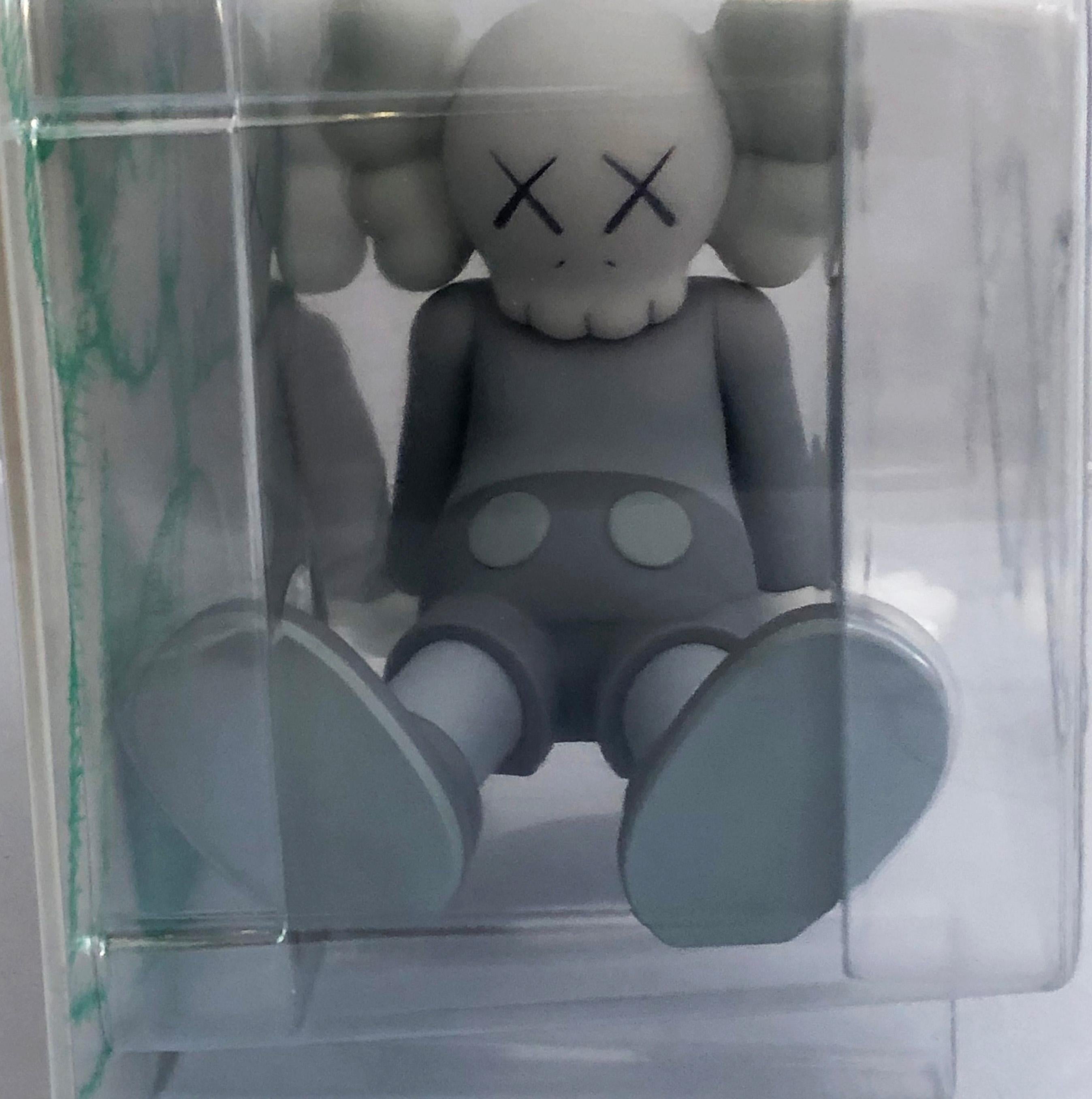 kaws sitting down drawing