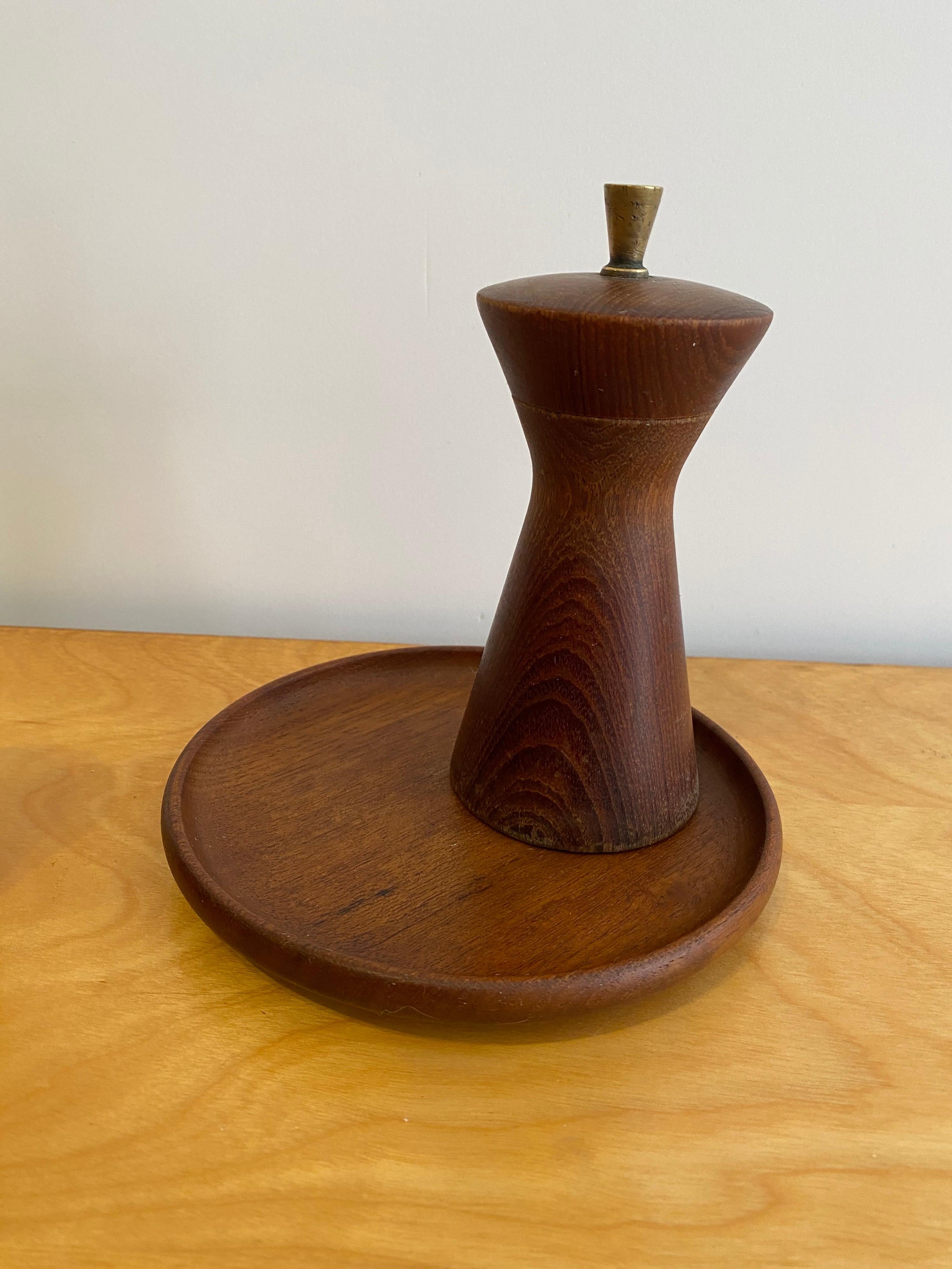 Kay Bojesen 3 piece teak condiment set. Known for his articulated Jointed Monkey, Bojesen alson produced some outstanding Danish designs for dining as well! Turned from teak this set includes a round tray with rim, pepper mill and small lidded