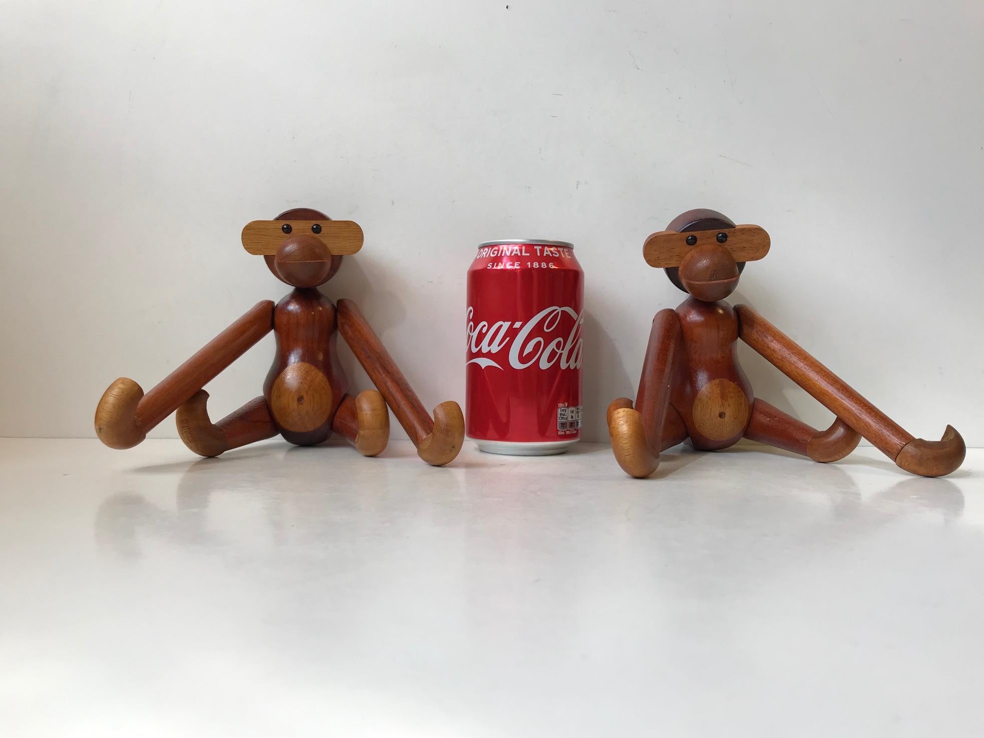 Set of two wooden monkeys designed by Kay Bojesen. Made of solid teak and limba wood. They features articulated limbs and movable heads The Kay Bojesen monkey has transformed kids rooms into jungles and sparked dreams of far-away places since 1951.