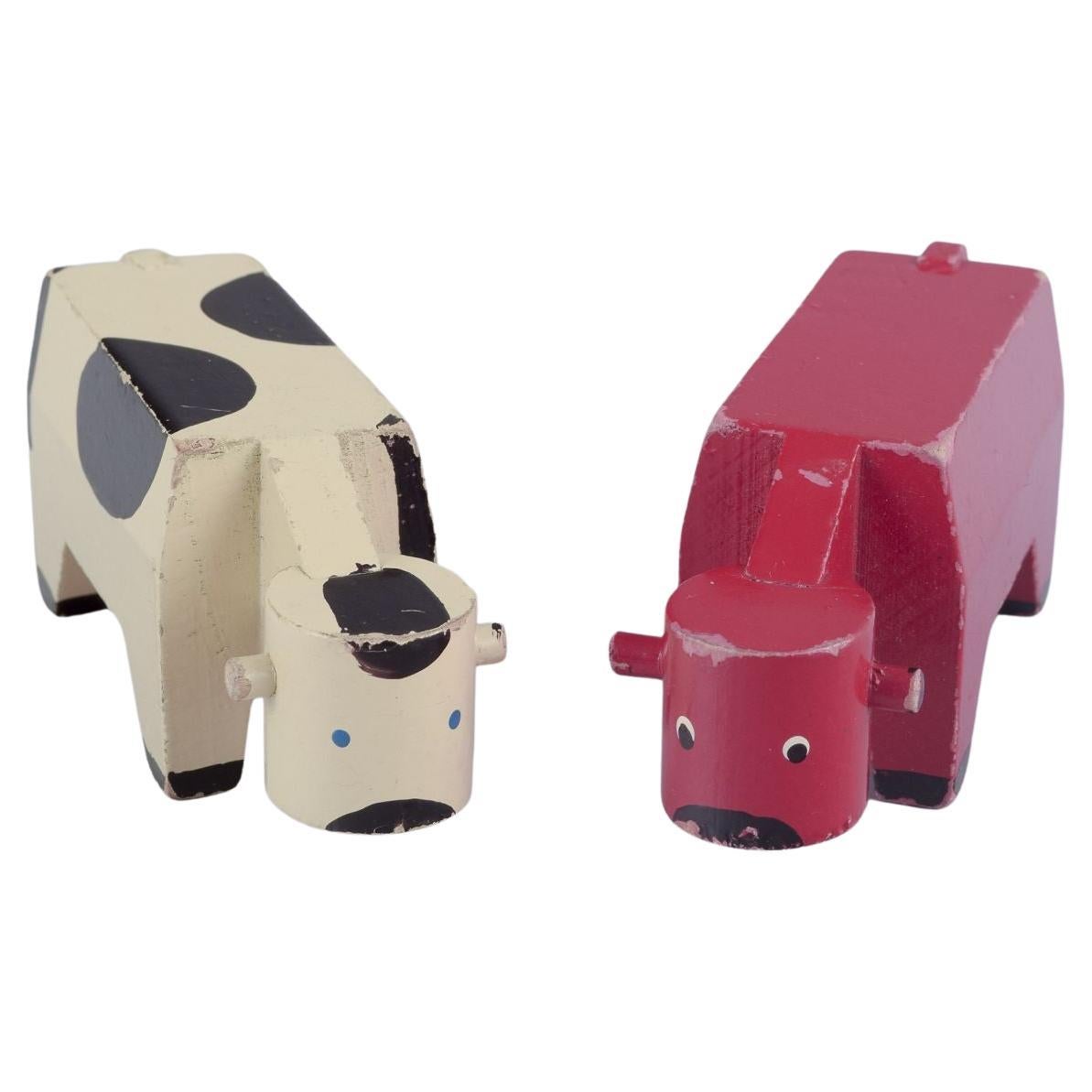 Kay Bojesen, Danish designer. Two early wooden figures of cows, mid-20th C.