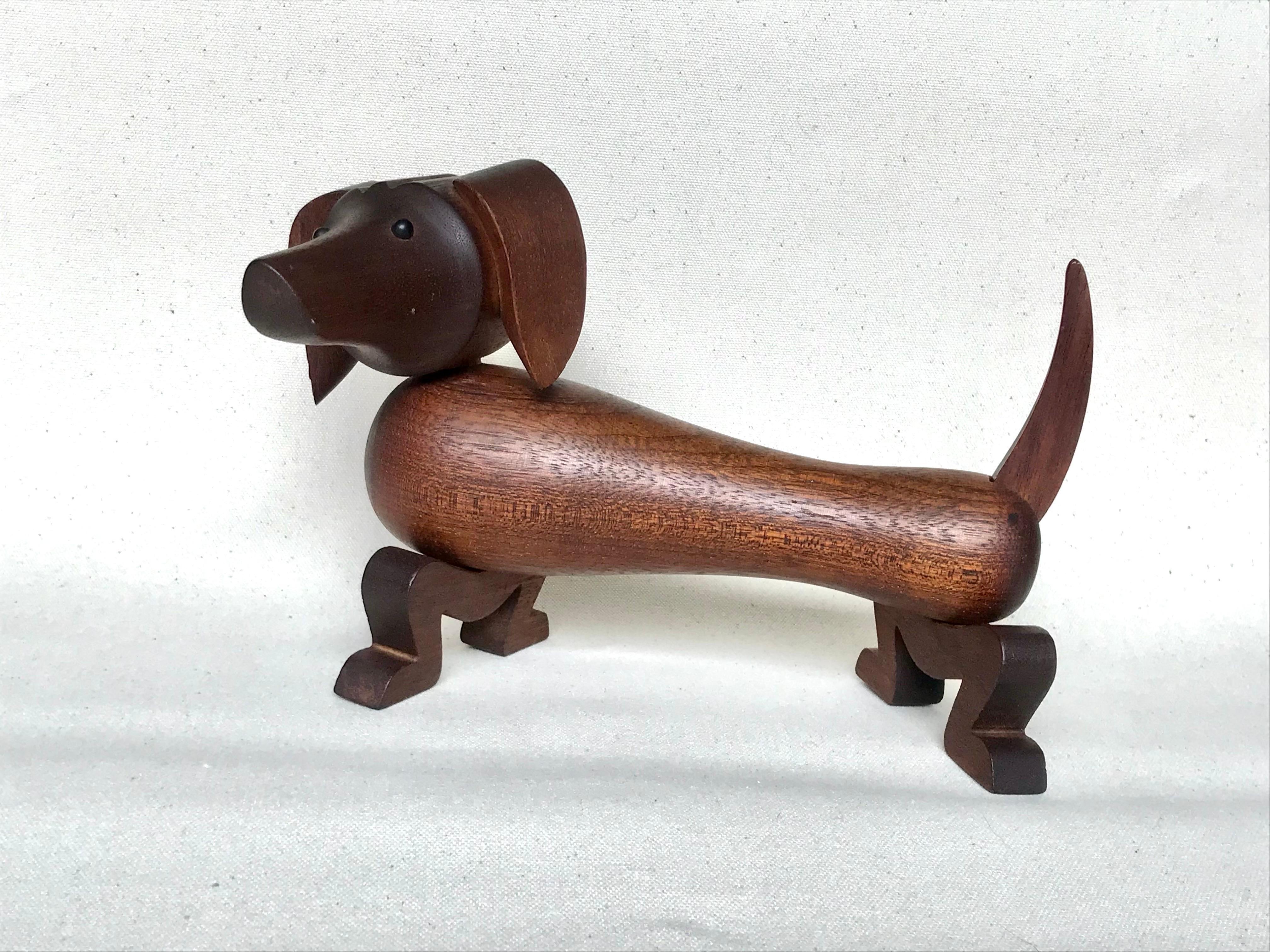 A playful danish modern design.
Early production piece.
Solid teak wood.
Head moves around, legs side to side and the tail up or down. 
Stamped 
