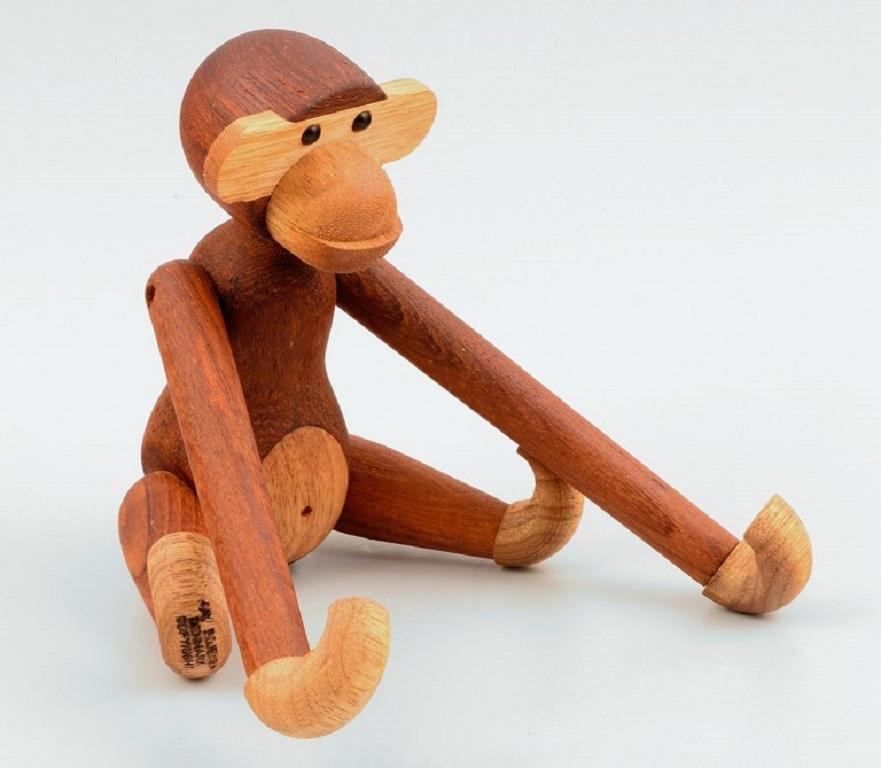 Kay Bojesen monkey, originally designed in 1951.
Made of teak and limba wood. 
Danish design.
The monkey is a classic gift for baptism, graduation, birthdays and so on.
2000s.
Heights 19 cm. 
Marked.
In good condition.
