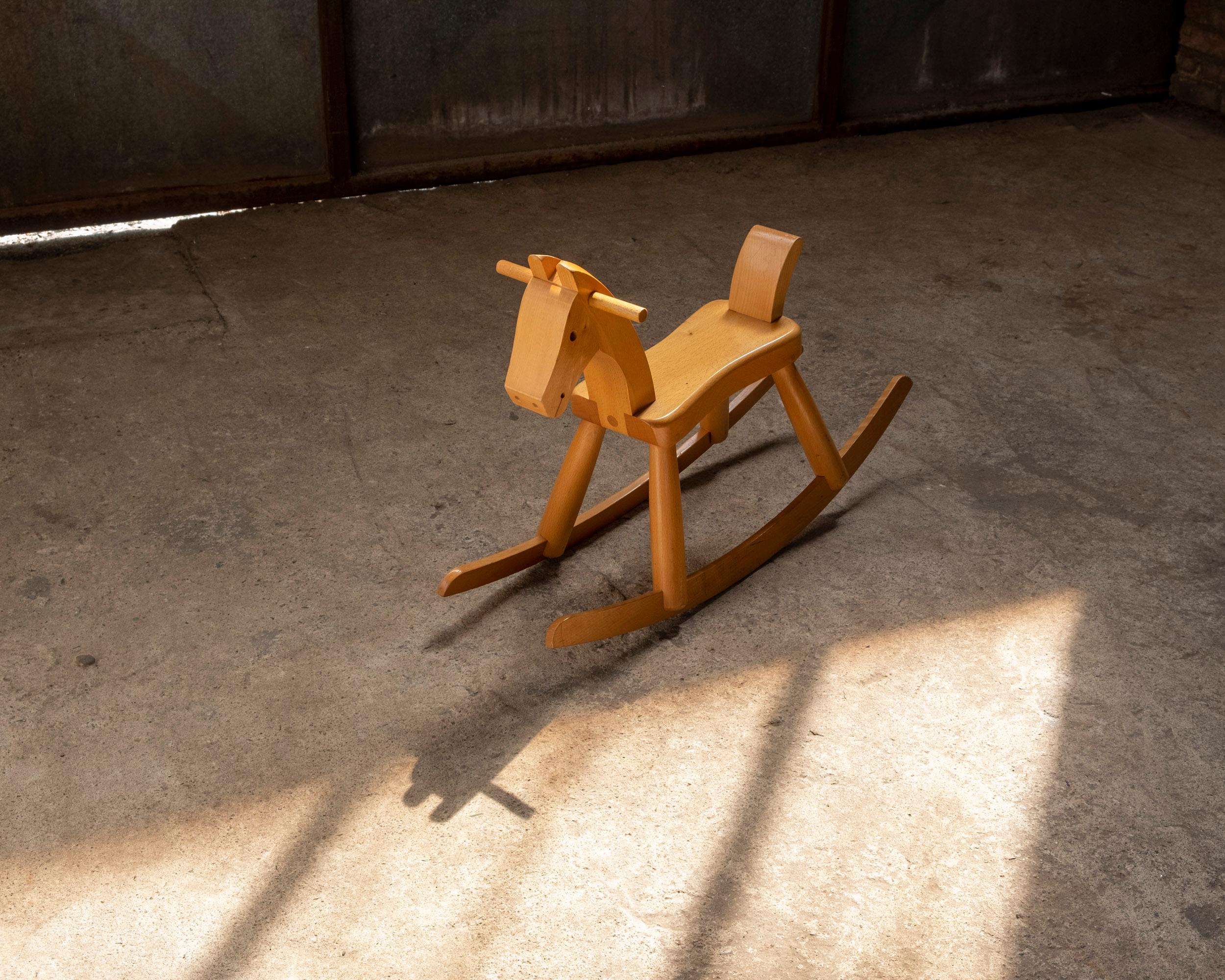 Vintage original Kay Bojesen rocking horse. Made from solid beech with a lacquered finish.
 Stamped on the underside Kay Bojesen, Denmark. Originally designed in 1936.
 
Measurements (HxWxD): 47cm x 24cm x 77cm, Seat height 26cm.

Light scratches