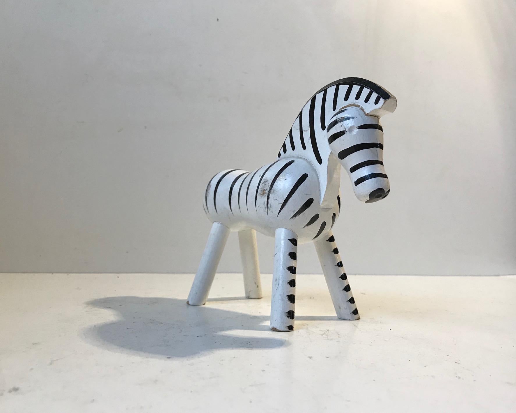 A wooden toy zebra made from Danish beech and hand painted white and black.
It was designed by Kay Bojesen in 1936. This particular example was manufactured in the 1950s. It has been played with and it shows in the most charming way and in all the