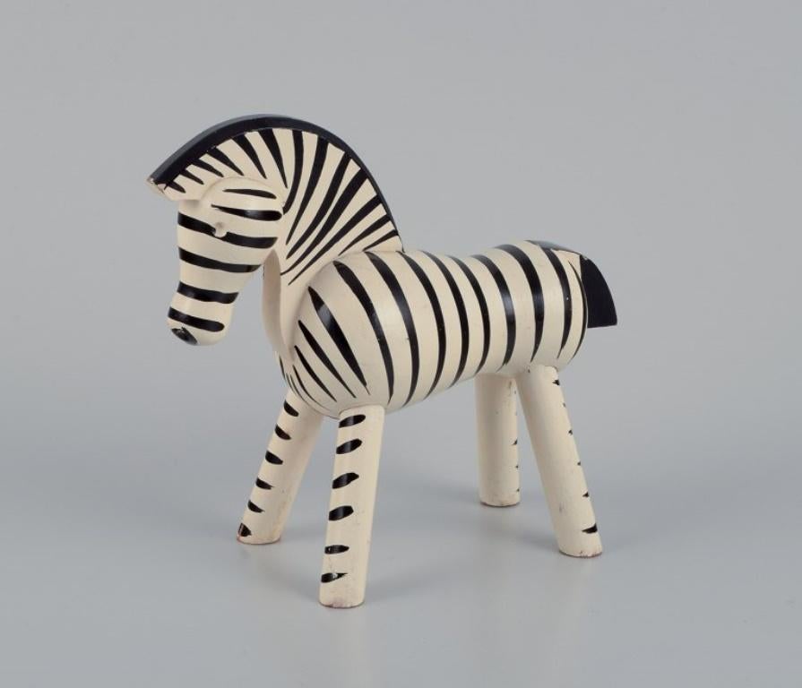 Kay Bojesen (1886-1958),a well-known Danish silversmith and designer. 
Wooden figurine of a zebra.
Hand-painted. Early edition.
Mid-20th century.
Label.
In very good condition.
Dimensions: Length 16.0 cm x Height 13.5 cm