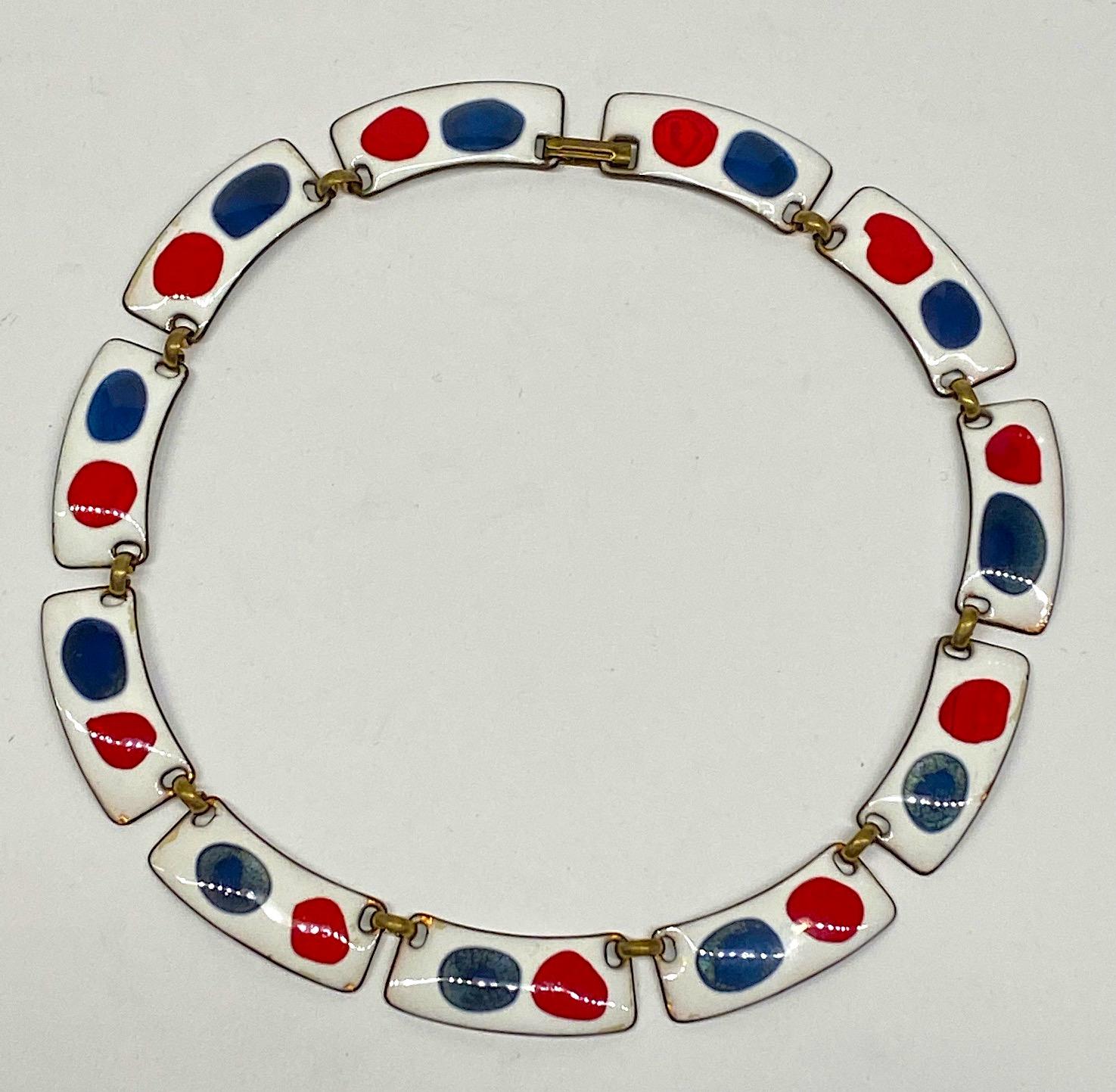 A lovely and cheerful red and blue on white enamel on copper necklace by artisan jeweler Kay Denning from the 1960s. Each of the eleven links are lightly curved to make a perfect circle when worn around the neck. Each link is .5 of an inch wide, 1.5