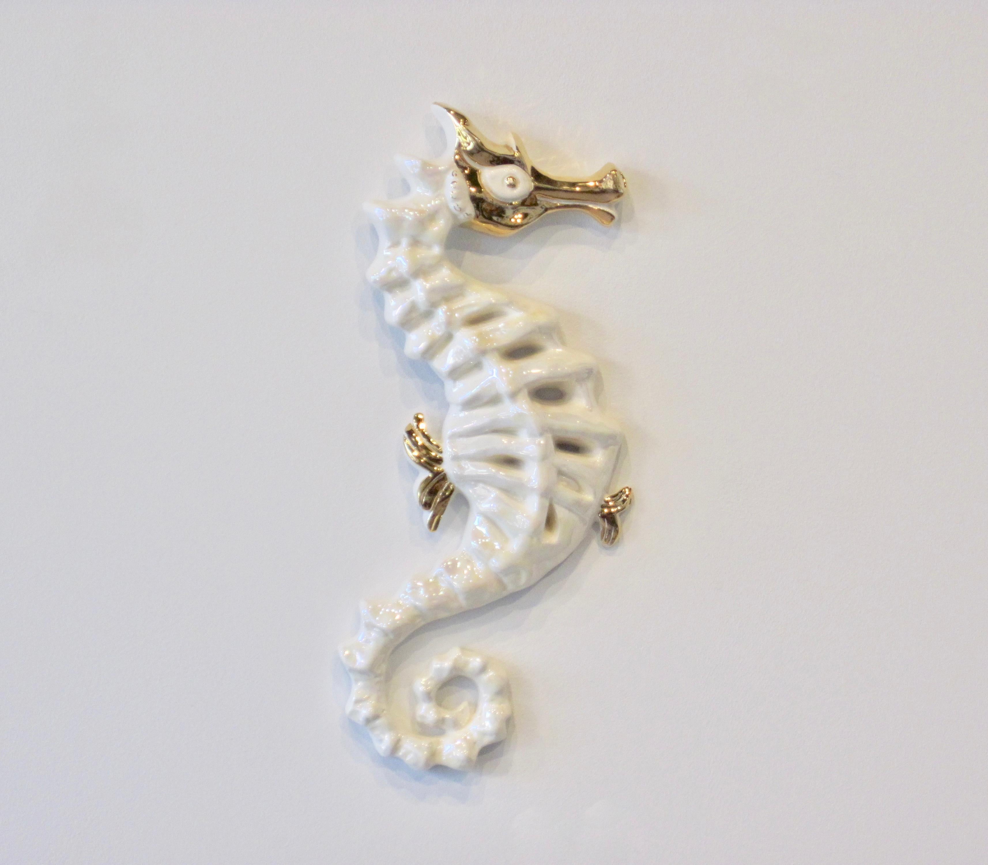 An early and rare Kay Finch(1903-1993) seahorse finely sculptured in pearlized white and gold. Hand-incised on underside.

Kay Finch Ceramics were made in Corona Del Mar, California, from 1935 to 1963. All her pieces were handmade and composed of