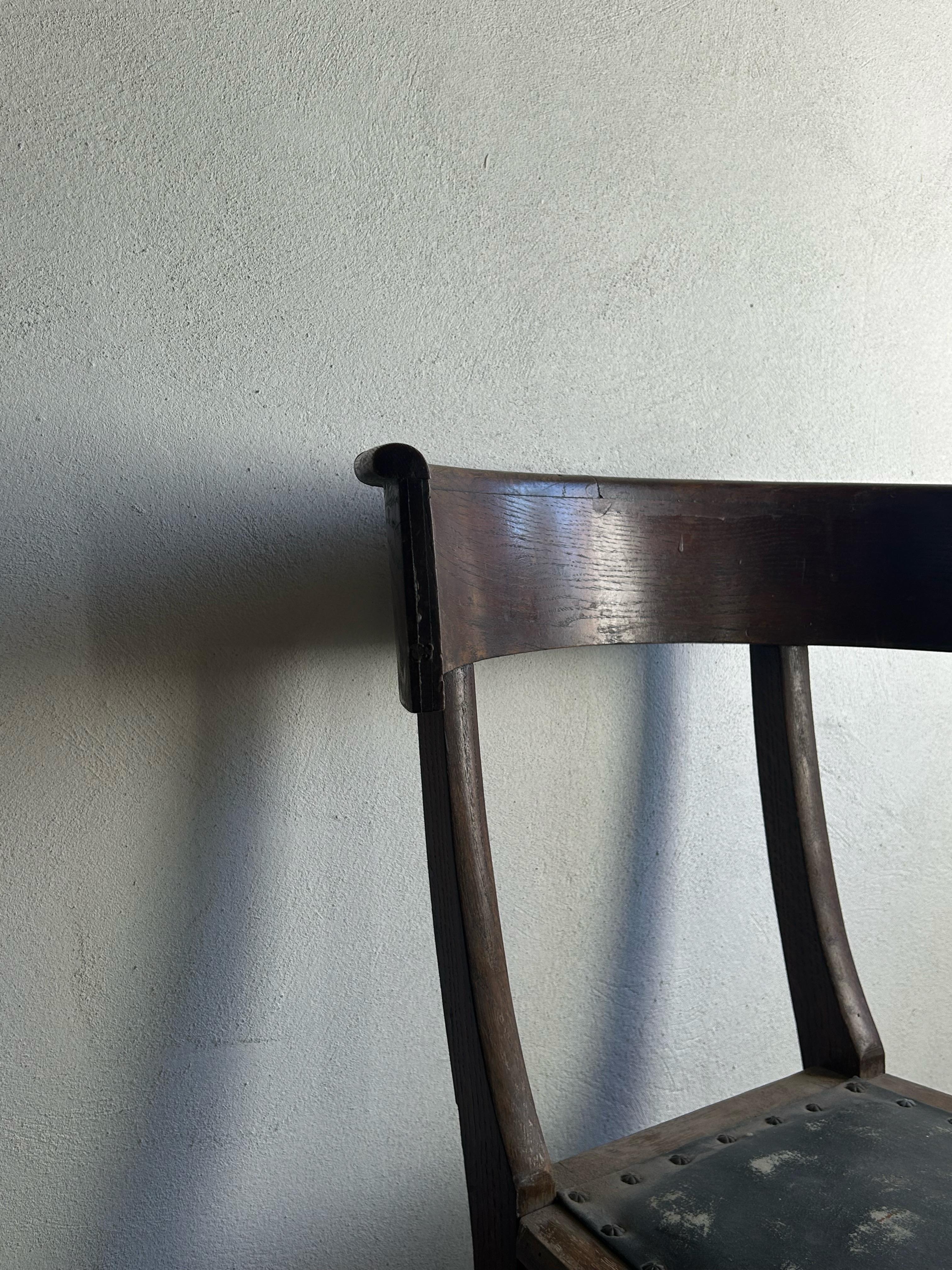 Refined Klismos chair attributed to Kay Fisker, crafted in stained oak and retaining its original leather upholstery. The chair embodies Fisker’s early architectural approach — a disciplined dialogue between classical form and modern