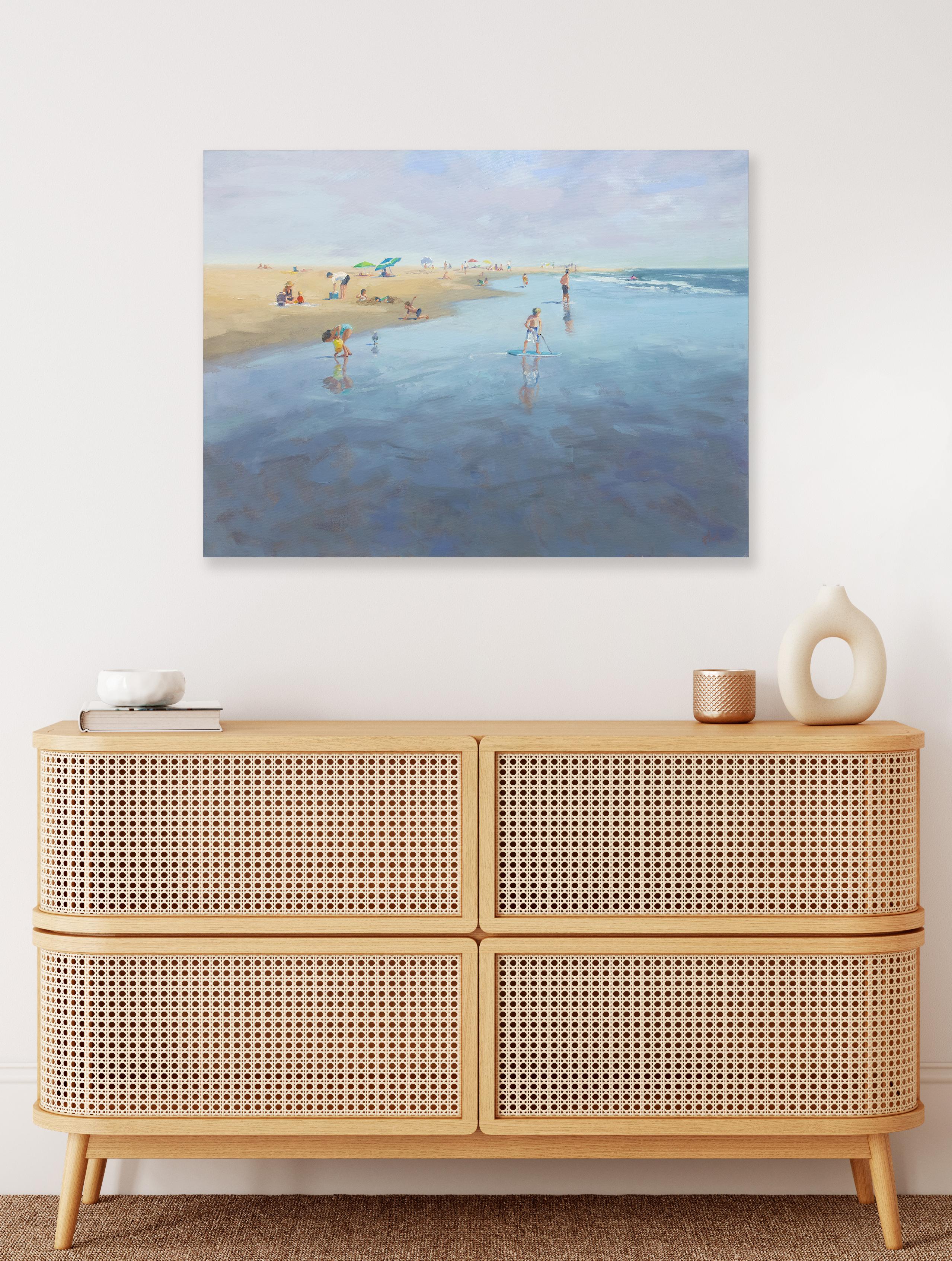 This coastal landscape paintings captures beach-goers lounging and playing along a shoreline, and features a cool palette and loose, painterly style. The painting is made with oil paint on gallery wrapped canvas, and has neutral painted sides. It is