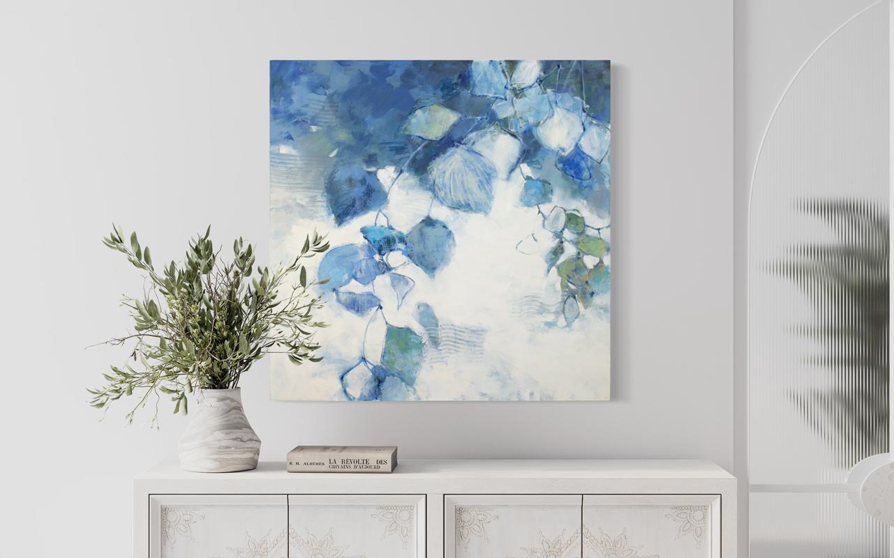 This abstract floral painting by Kay Flierl is made with oil on canvas and features a cool blue and white palette with earthy green accents. Painted abstract botanical shapes fan from the top right corner down toward the bottom edge of the canvas