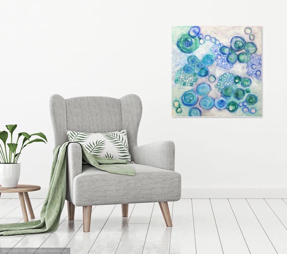 Kay Hartung’s “Bio Flow 20” is a 30 x 30 x 2.5 inch encaustic and mixed media painting composed of microscopic forms moving and multiplying. In colors of blues, greens, and whites, the order and chaos of these biological processes are captured in