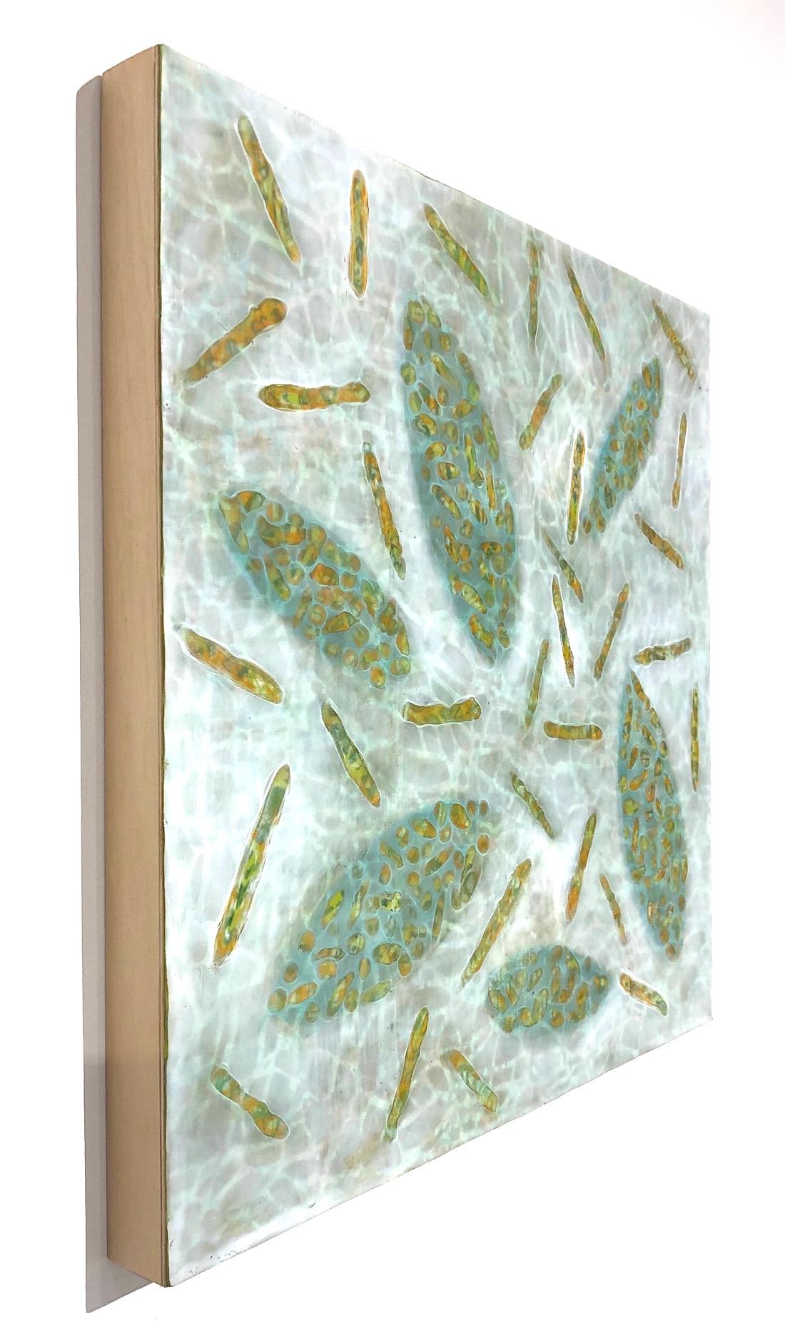 Kay Hartung’s “Bio Patterns 18” is a 20 x 20 x 1.5 inch encaustic painting composed of transparent layers depicting microscopic forms on a richly patterned background. In colors of green, white, yellow and orange, the transparent layers create a
