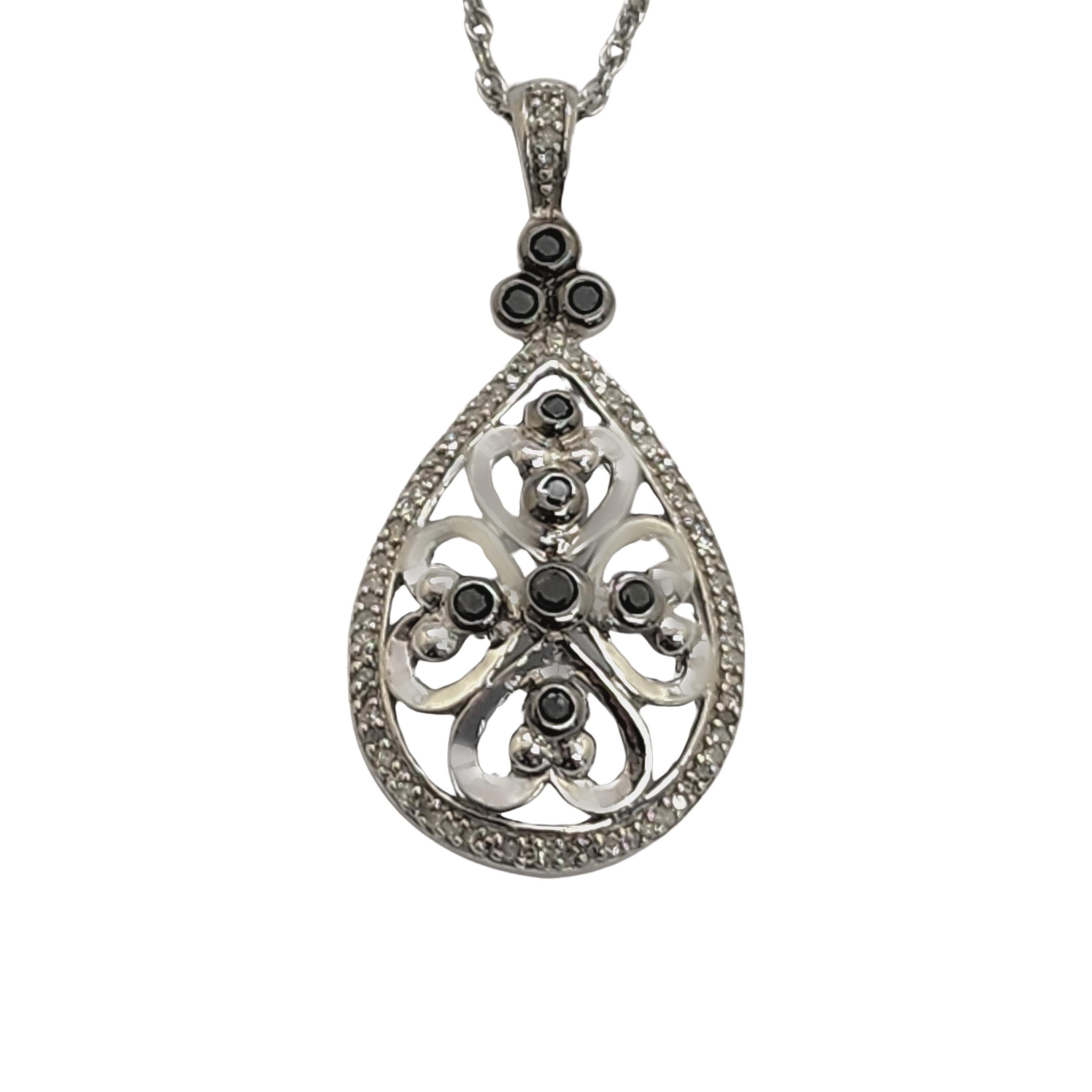 Kay Jewelers sterling silver black and white diamond pendant necklace.

Open work teardrop shaped pendant features heart designs and round black diamonds. Very small white diamonds frame the pendant. Delicate rope twist chain.

Chain measures approx