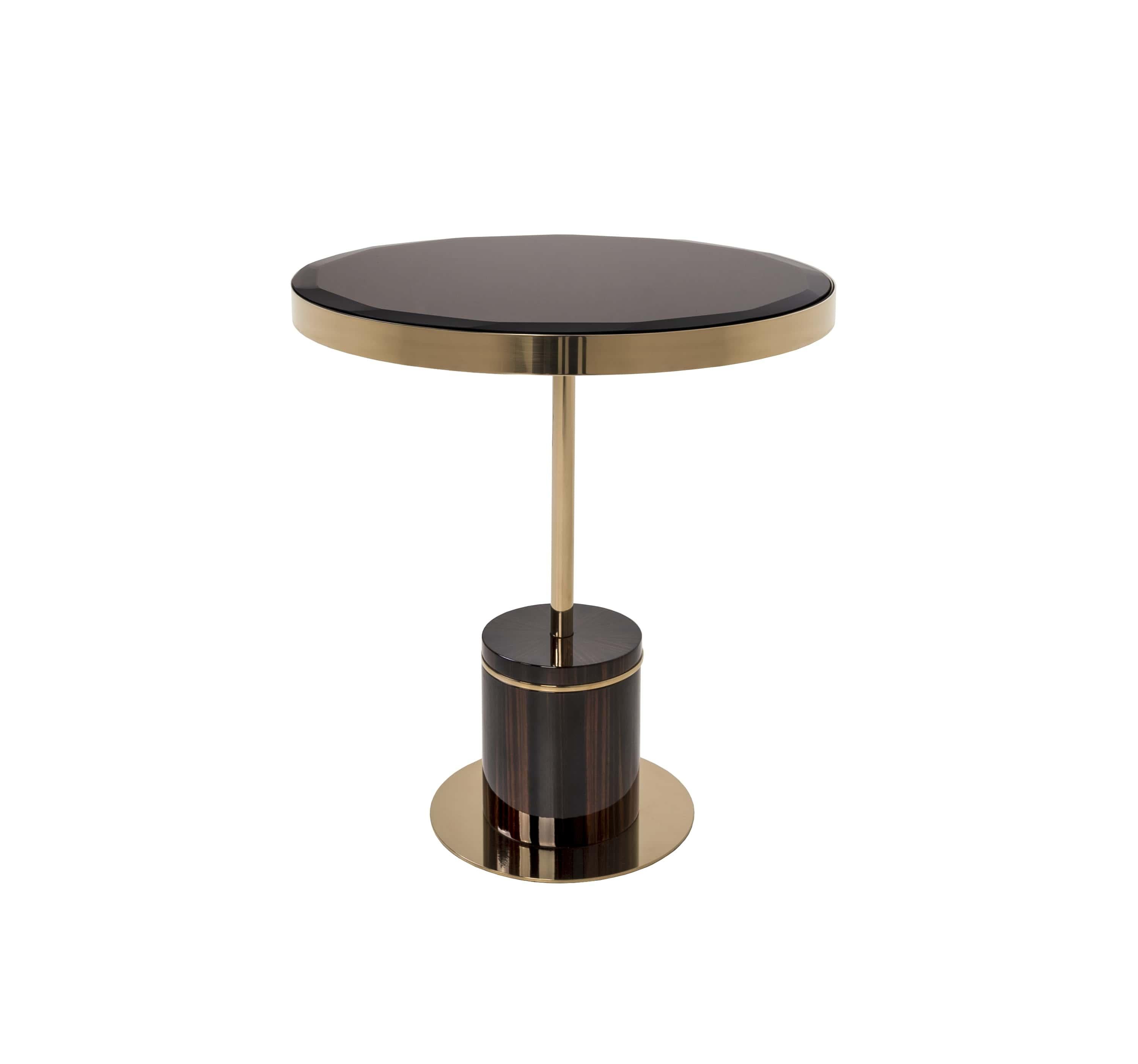The Kay Side Table is a striking blend of luxury and modern craftsmanship. Featuring a rich ebony base, highlighted with brass accents, it exudes refined elegance. The round top, with beveled edges, adds a contemporary touch while reflecting light